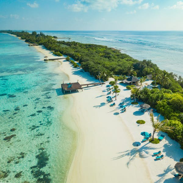 Coastline and clear blue waters in the Maldives.