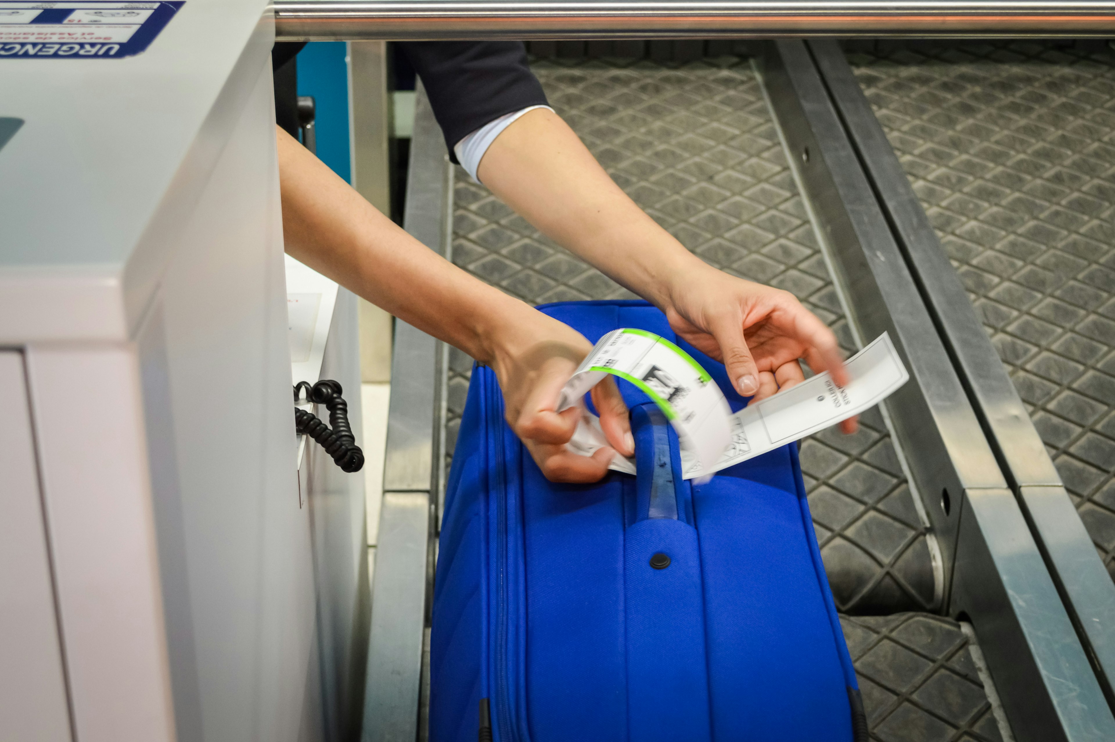 Photo of for colorful luggage being checked in at airport