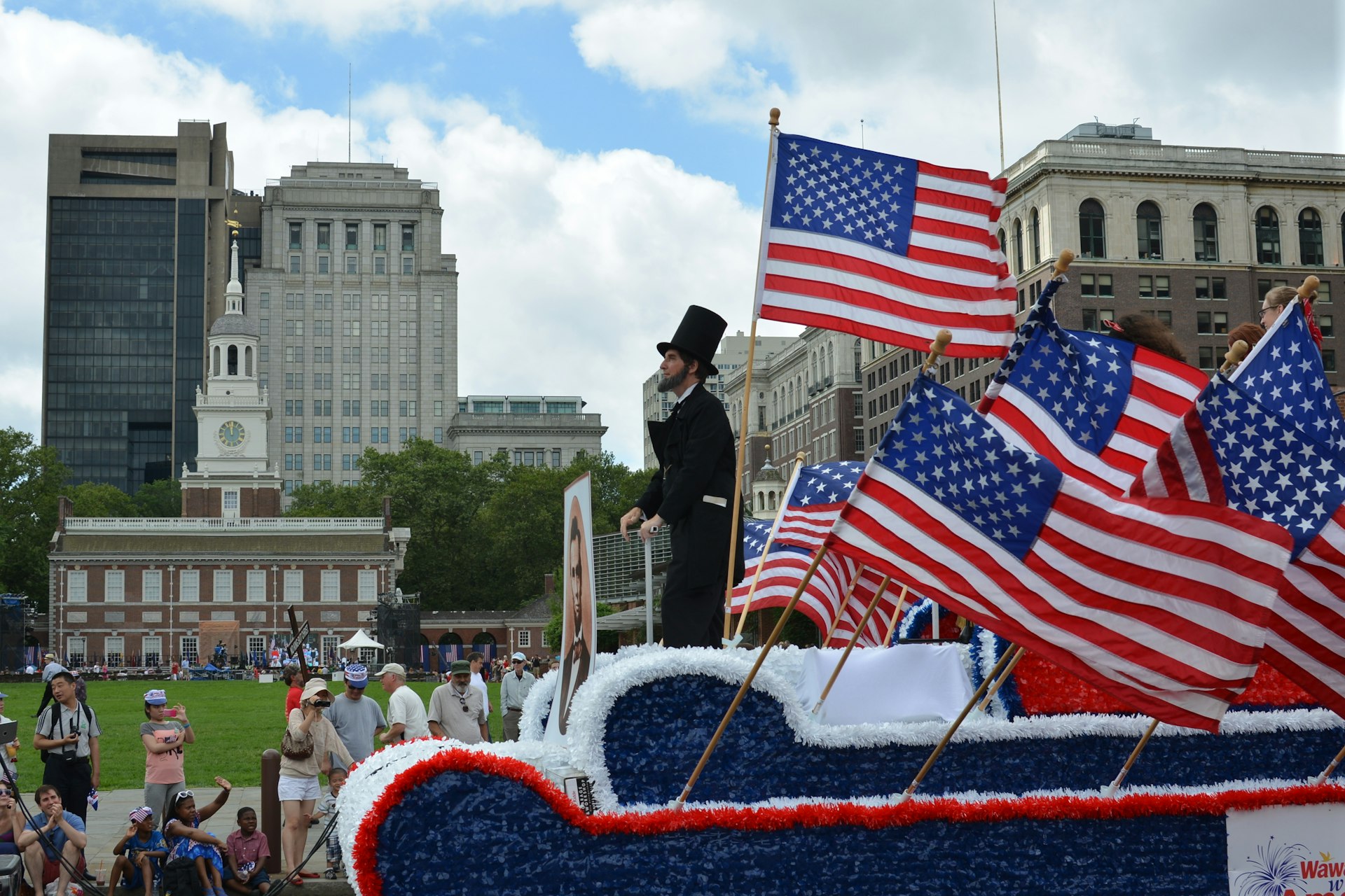 Abraham Lincoln rides a float in the Independence Day Parade as it makes its way along Market St in Philadelphia,