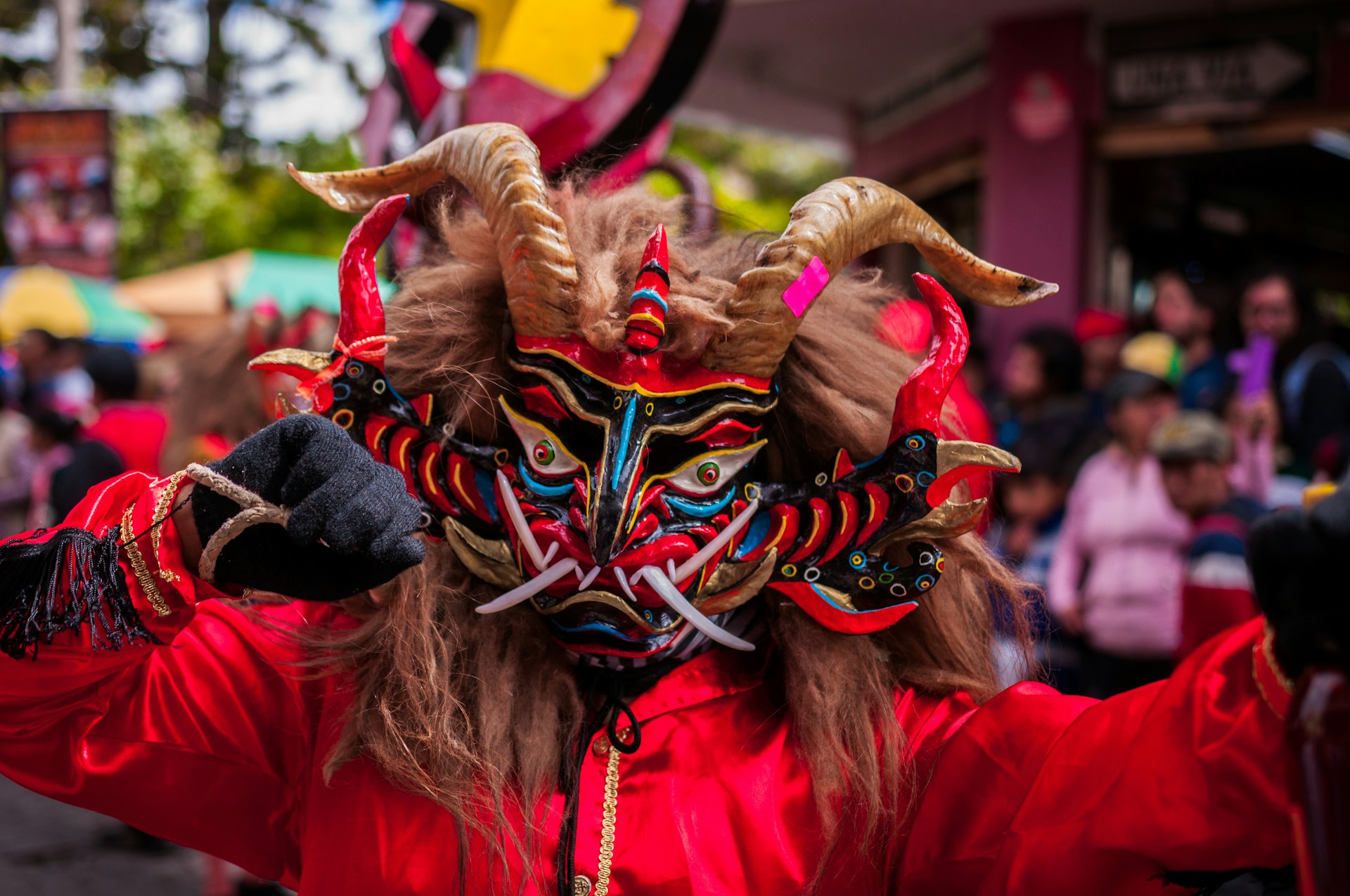 Person in a red devil mask at the Diablada or Devil Festival