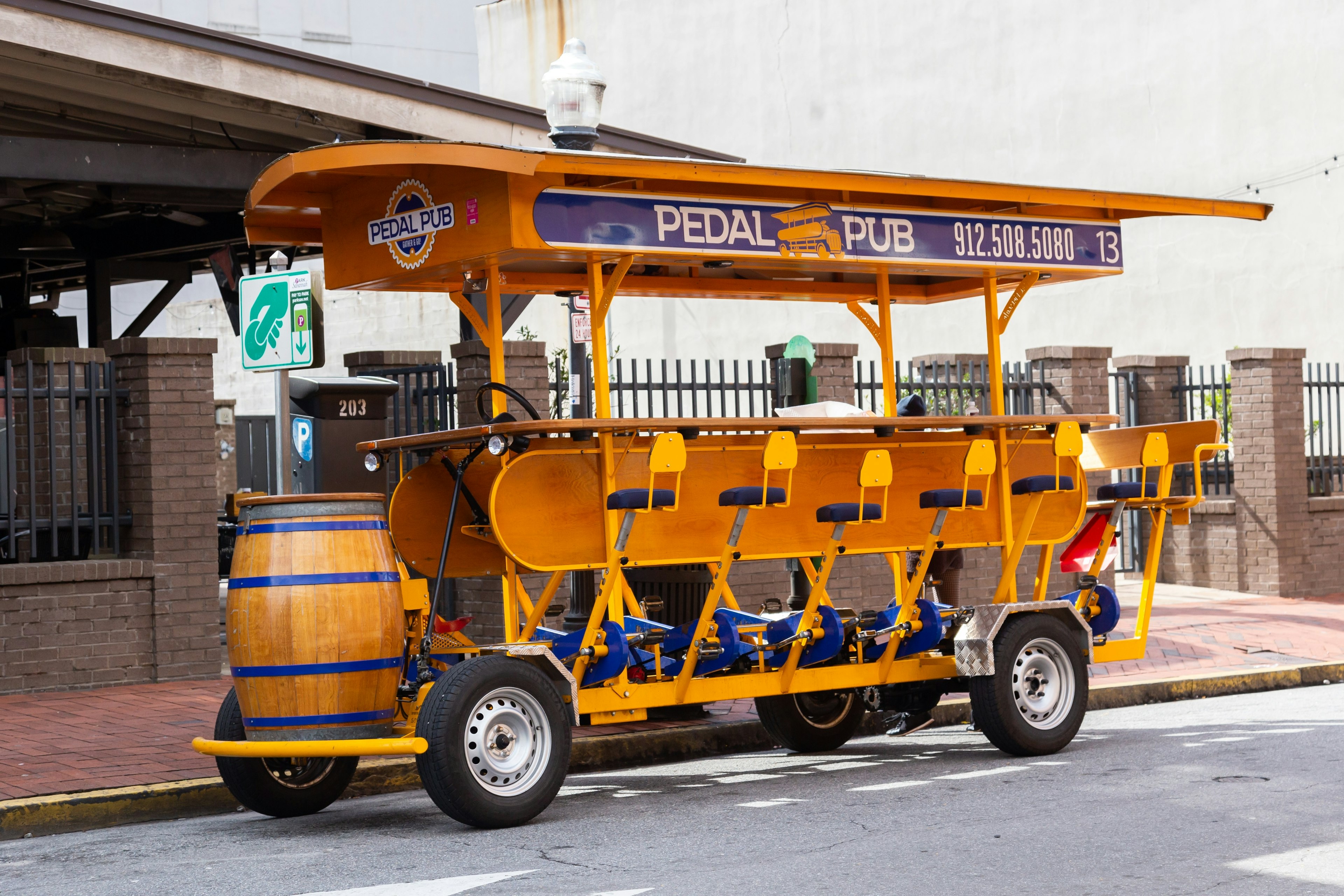 Cute empty Pedal Pub bus parked in street in the famous City Market sector in Savannah