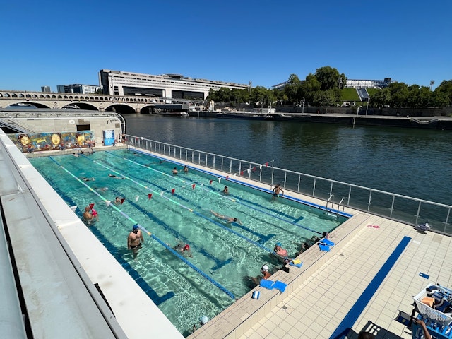 Swimmers enjoy the open-air floating Josephine Baker Pool in Seine, 13th arrondissement, Paris, France