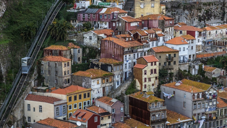 View from Dom Luis I Bridge on the old part of Porto city, including of the Funicular dos Guindais ascending the hill