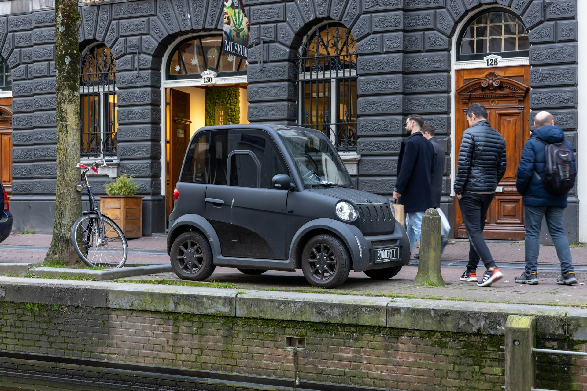 MOVE CityCar, a modern small electric car, in front of Hash Marihuana Museum, Amsterdam, the