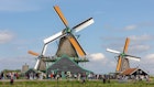 Traditional windmills with blue sky, A small village with tourist, Zaanse Schans is a neighborhood in the Dutch town Zaandijk near Amsterdam, Noord Holland