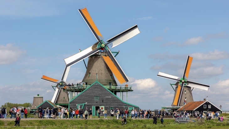 Traditional windmills with blue sky, A small village with tourist, Zaanse Schans is a neighborhood in the Dutch town Zaandijk near Amsterdam, Noord Holland
