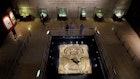 People look at El Rostro de la Diosa (The Face of the Earch Goddess) in a museum at the Templo Mayor in Mexico City, Mexico