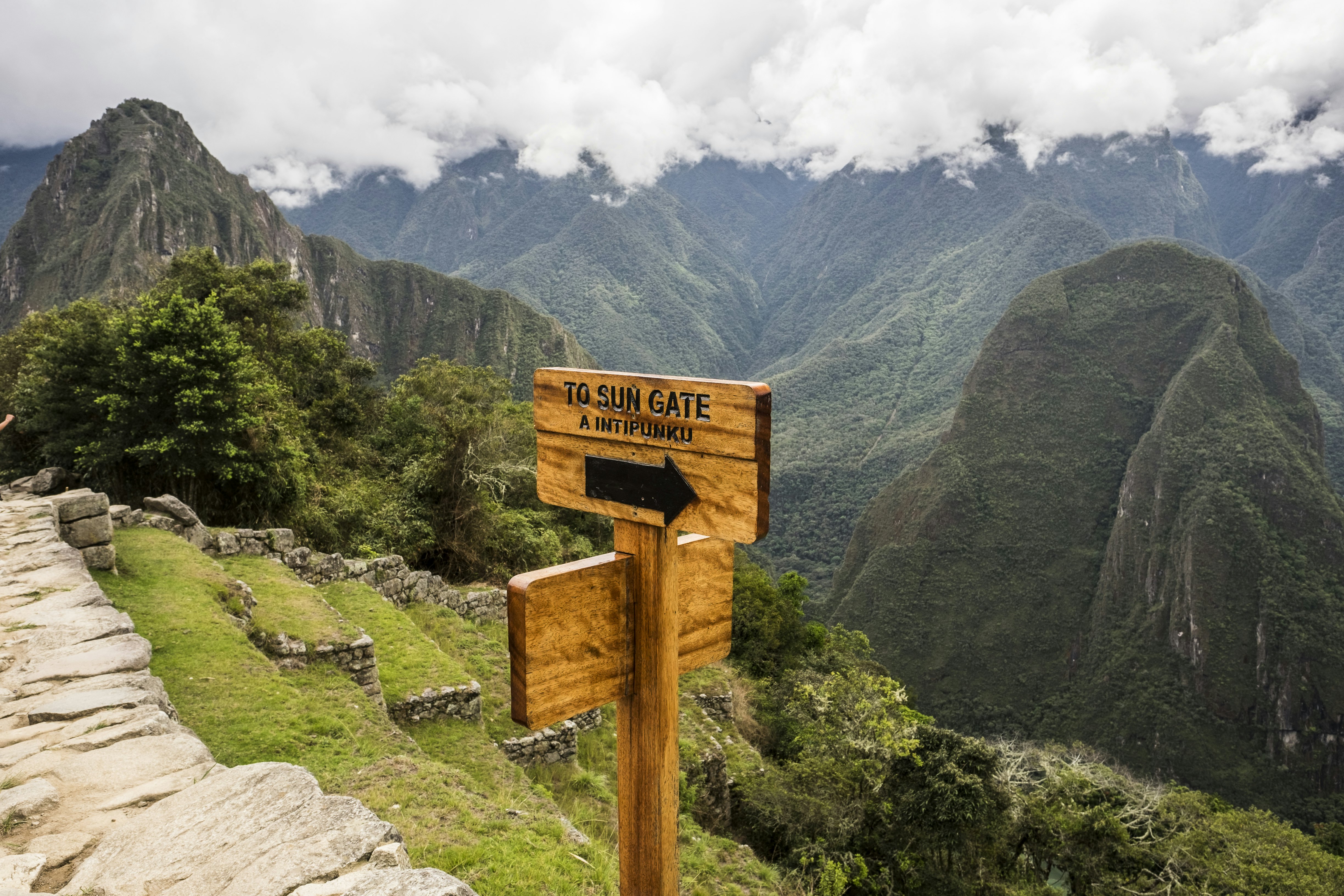 Sign showing the way to the Sun Gate, about a mile along a trail from the Machu Picchu site. The Sun Gate was once the main entrance from the south.