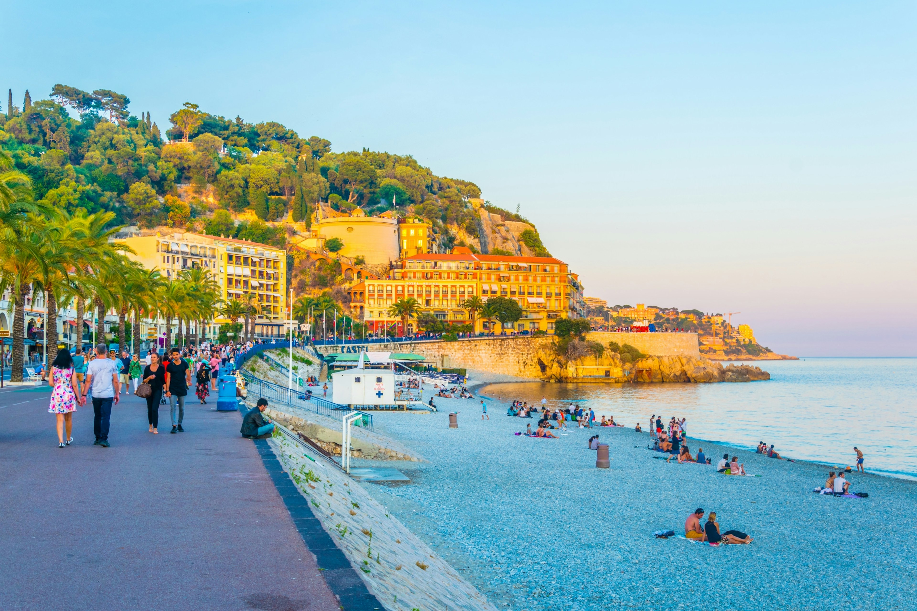 People strolling on the Promenade des Anglais during the late afternoon.