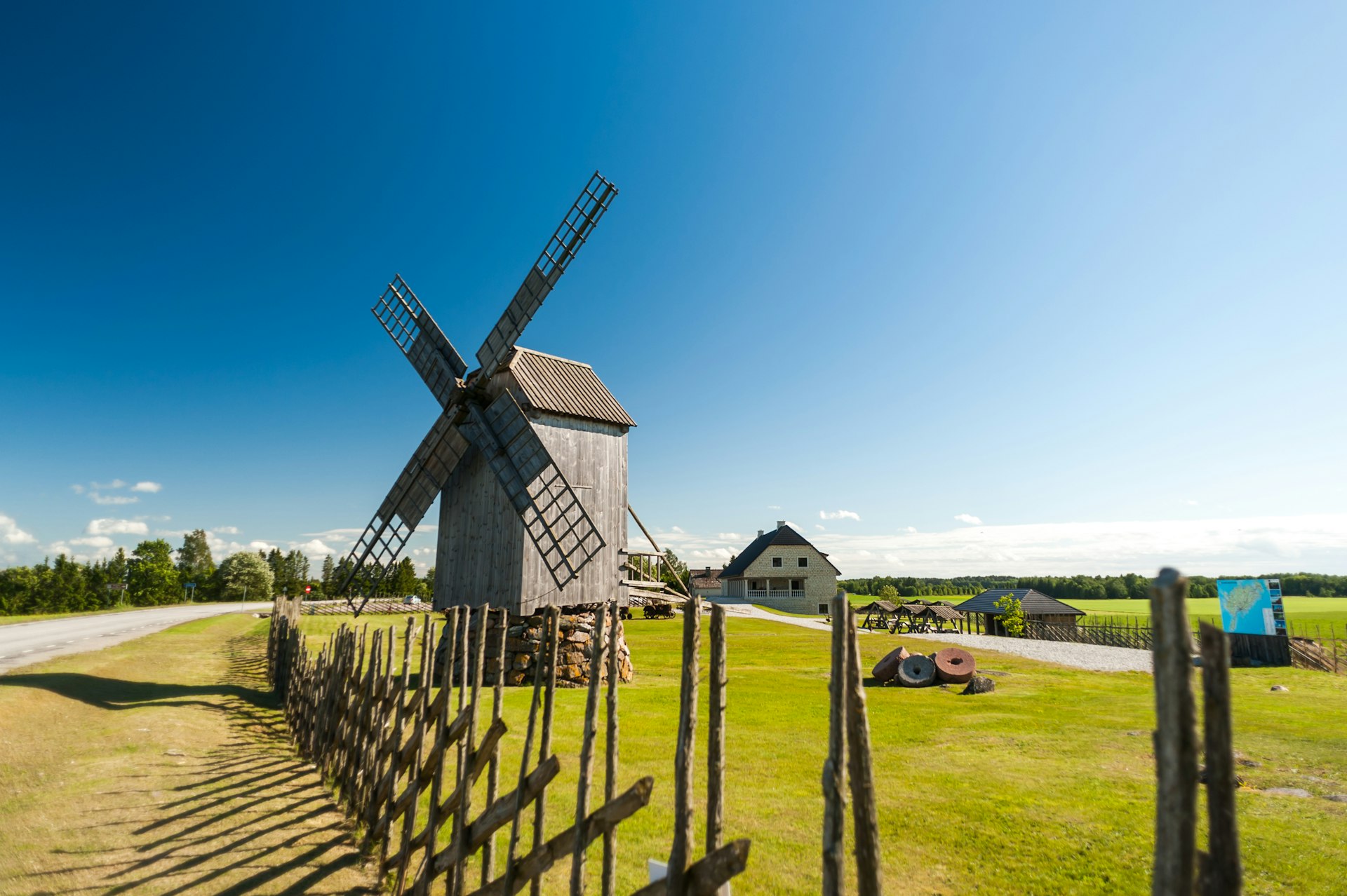 A wooden windmill in farmland