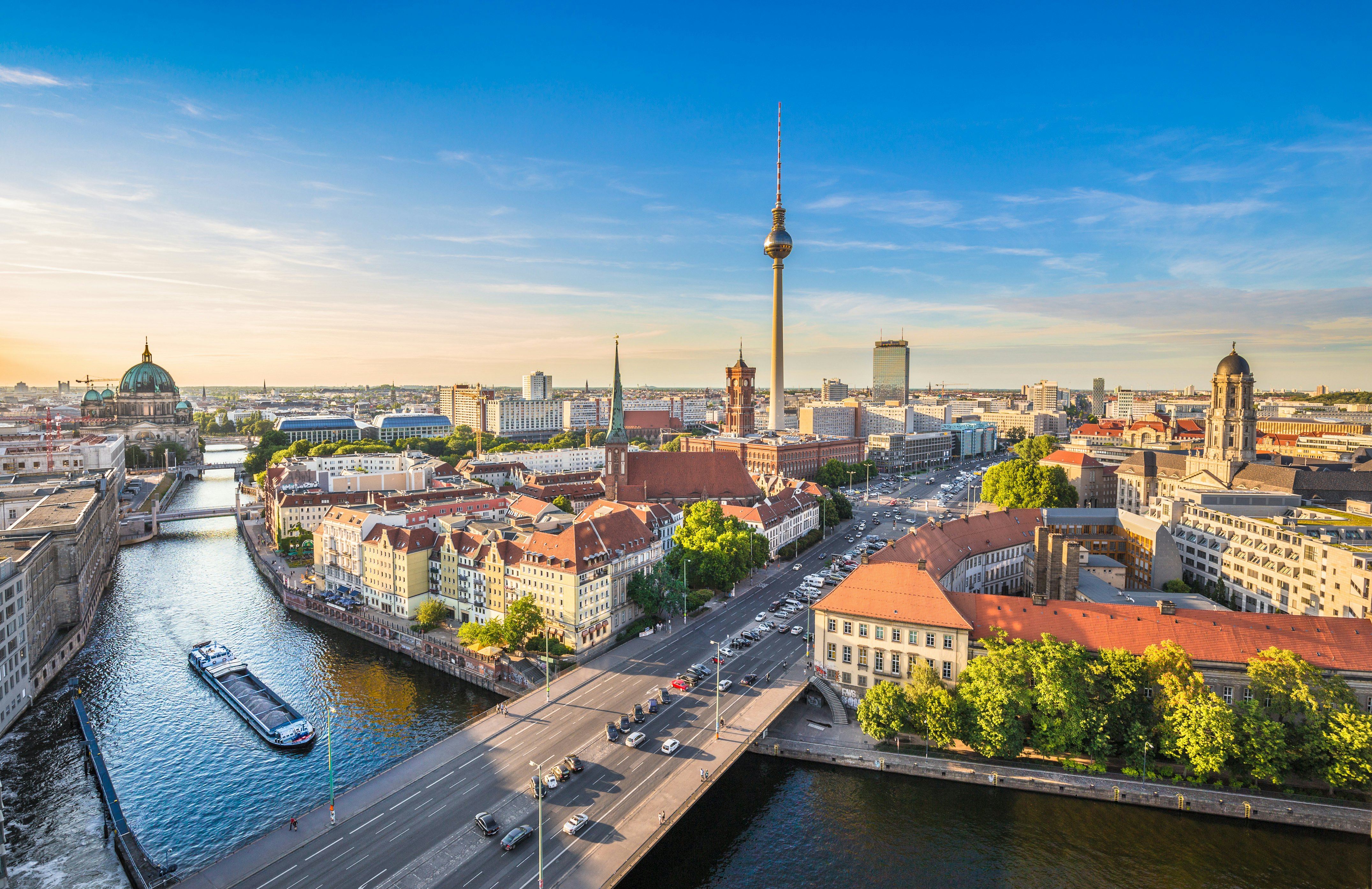 A cityscape and river with a tall TV tower in the center