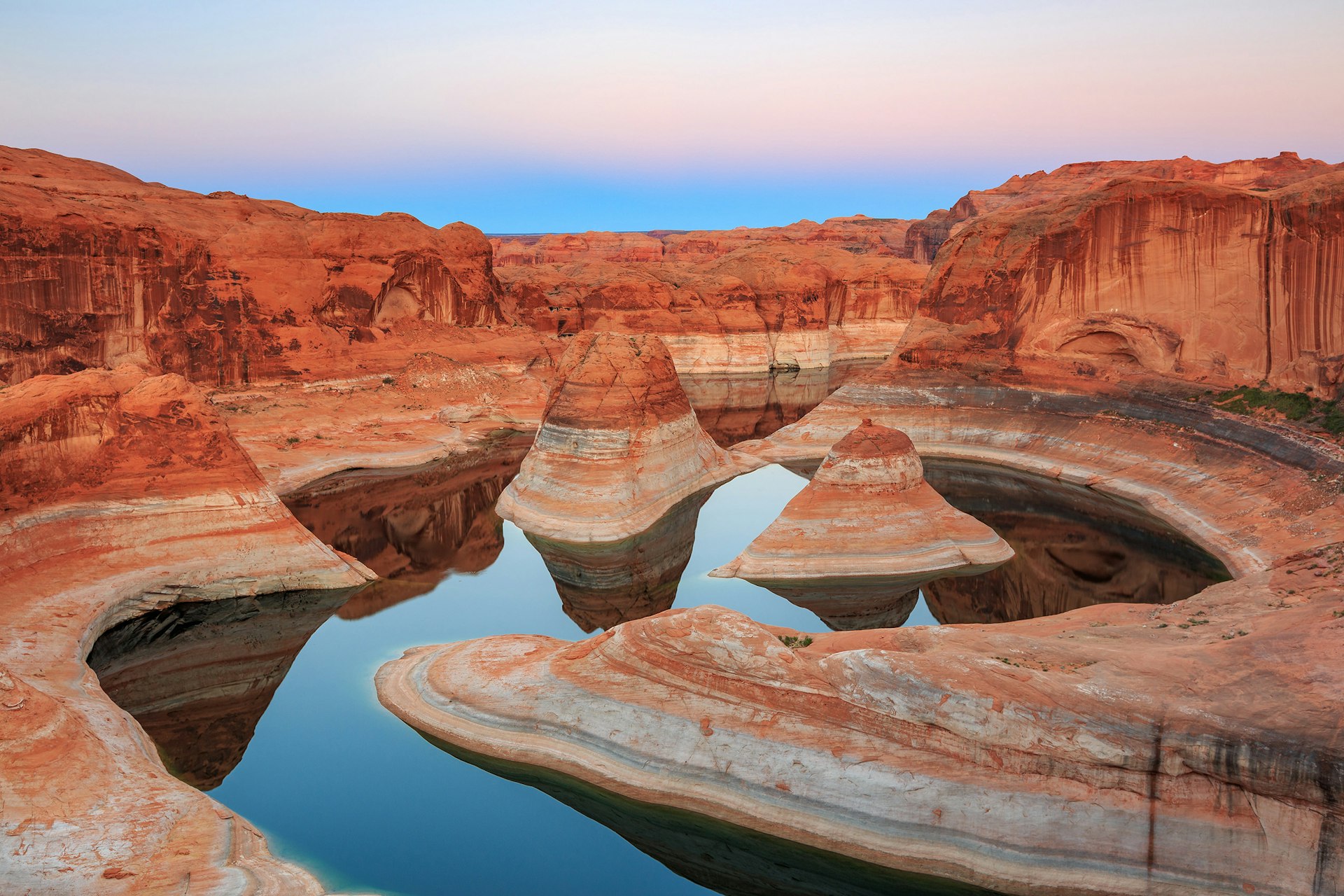 Reflection Canyon on Lake Powell, with canyon walls along the waters. 
