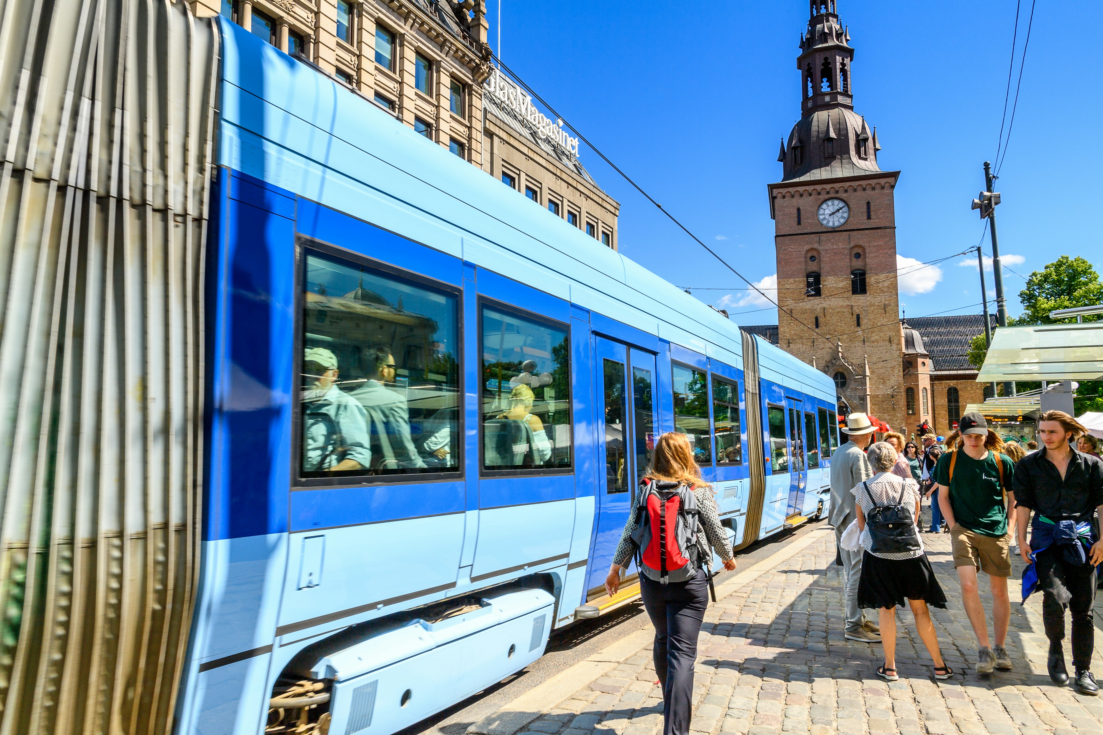 A woman heading to catch a tram in Oslo, the capital of Norway;