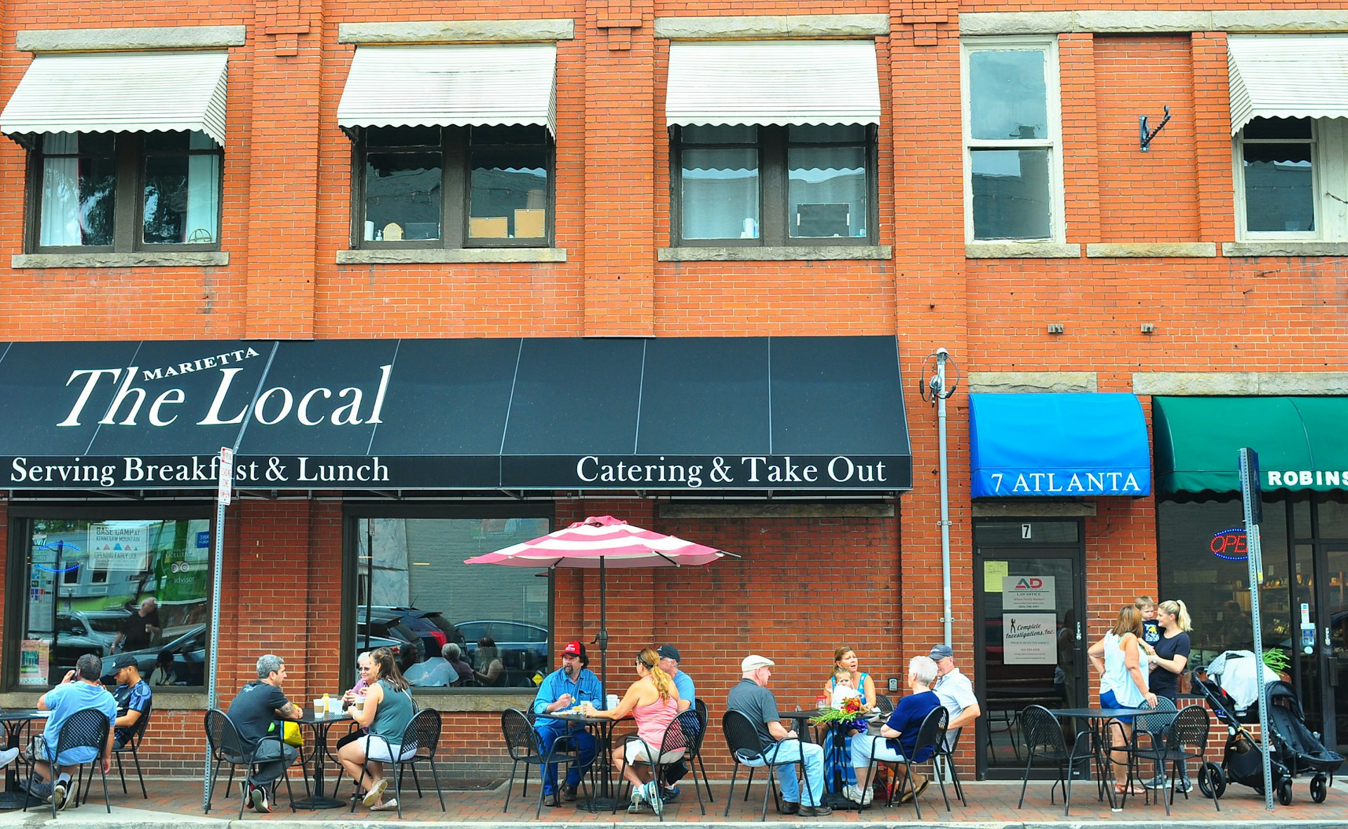 Local residents sit at patio tables outside of the Local in Marietta