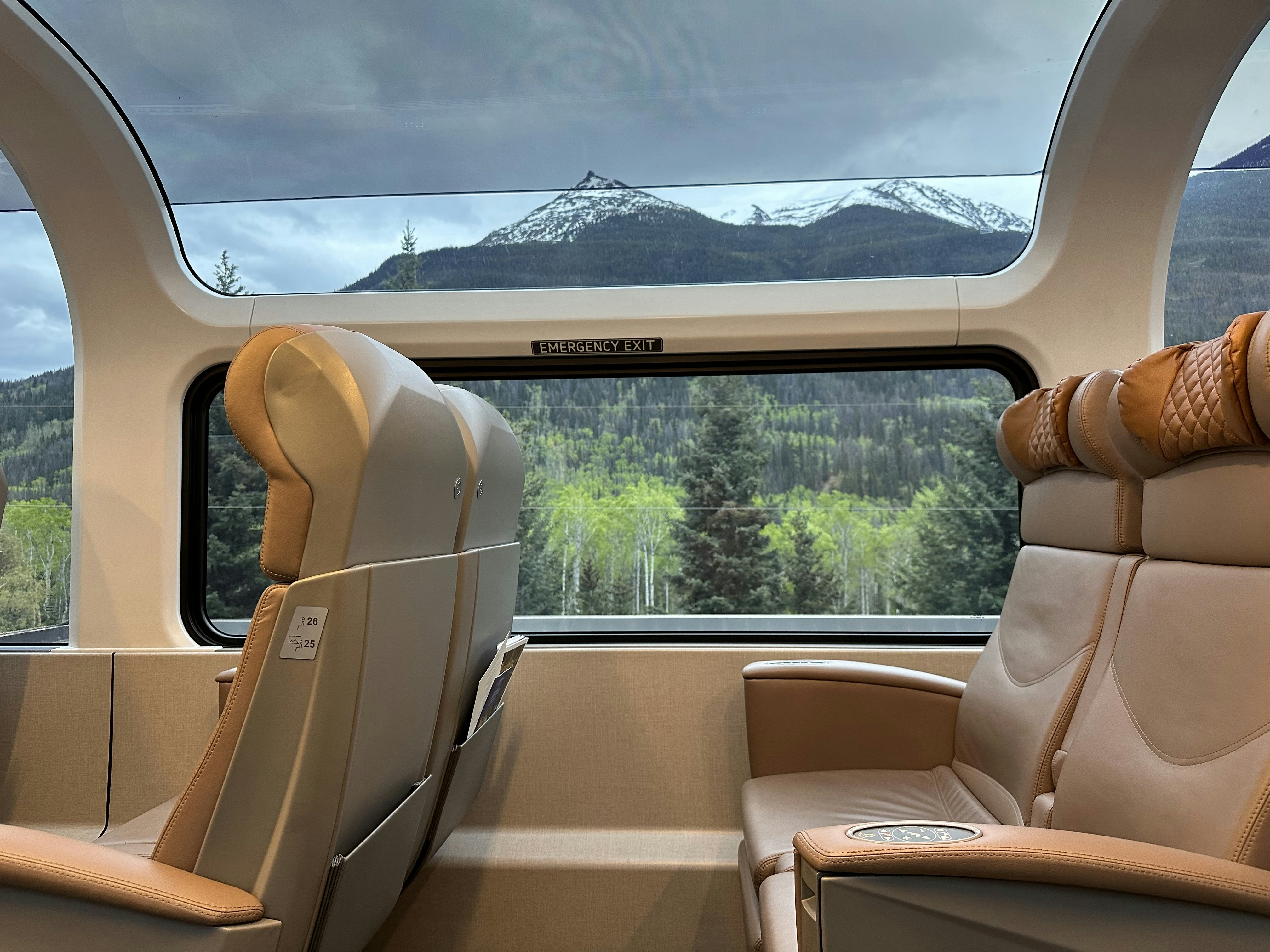 A mountain viewed from within a carriage on a scenic train ride