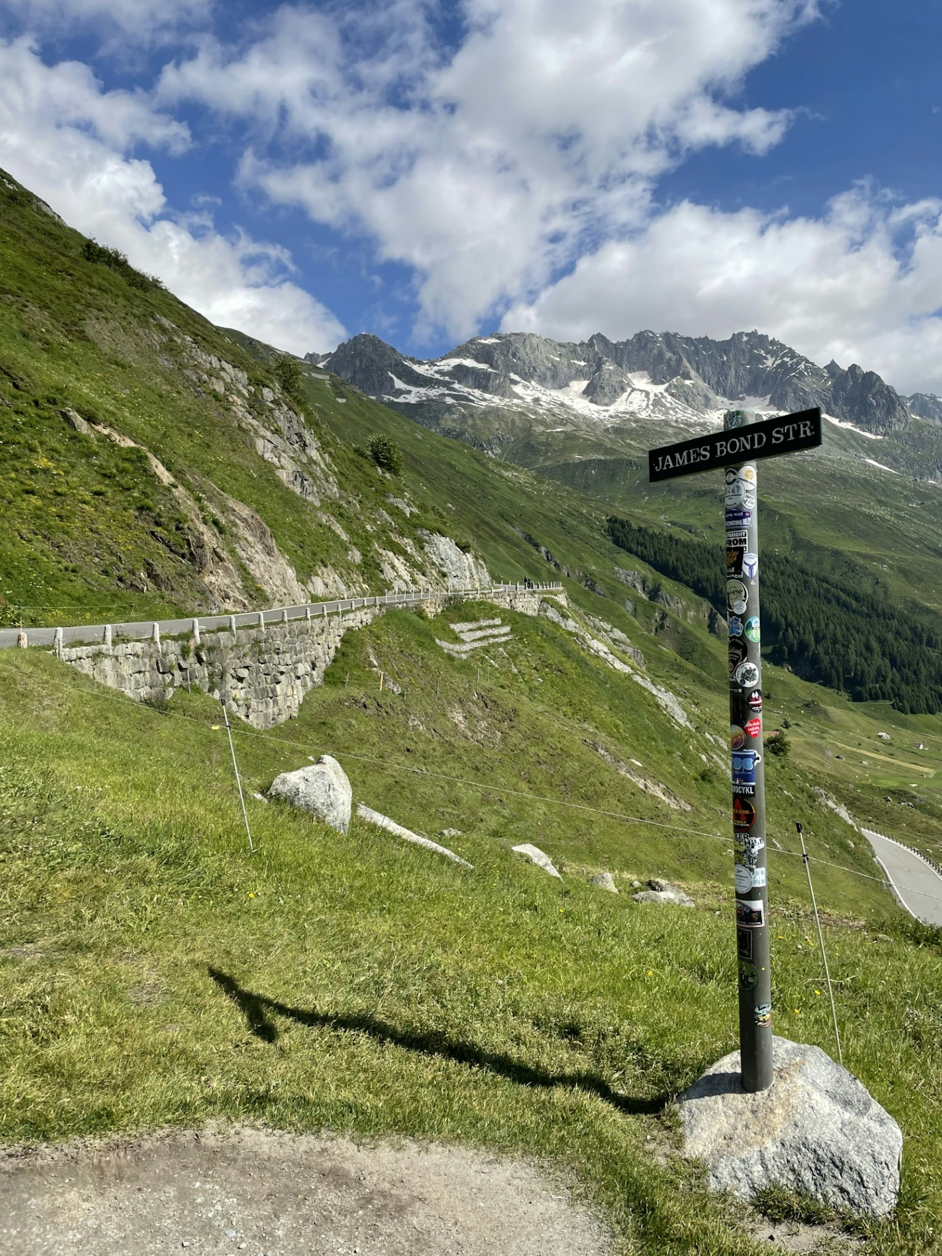 A road sign along a mountain pass says "James Bond Str" 