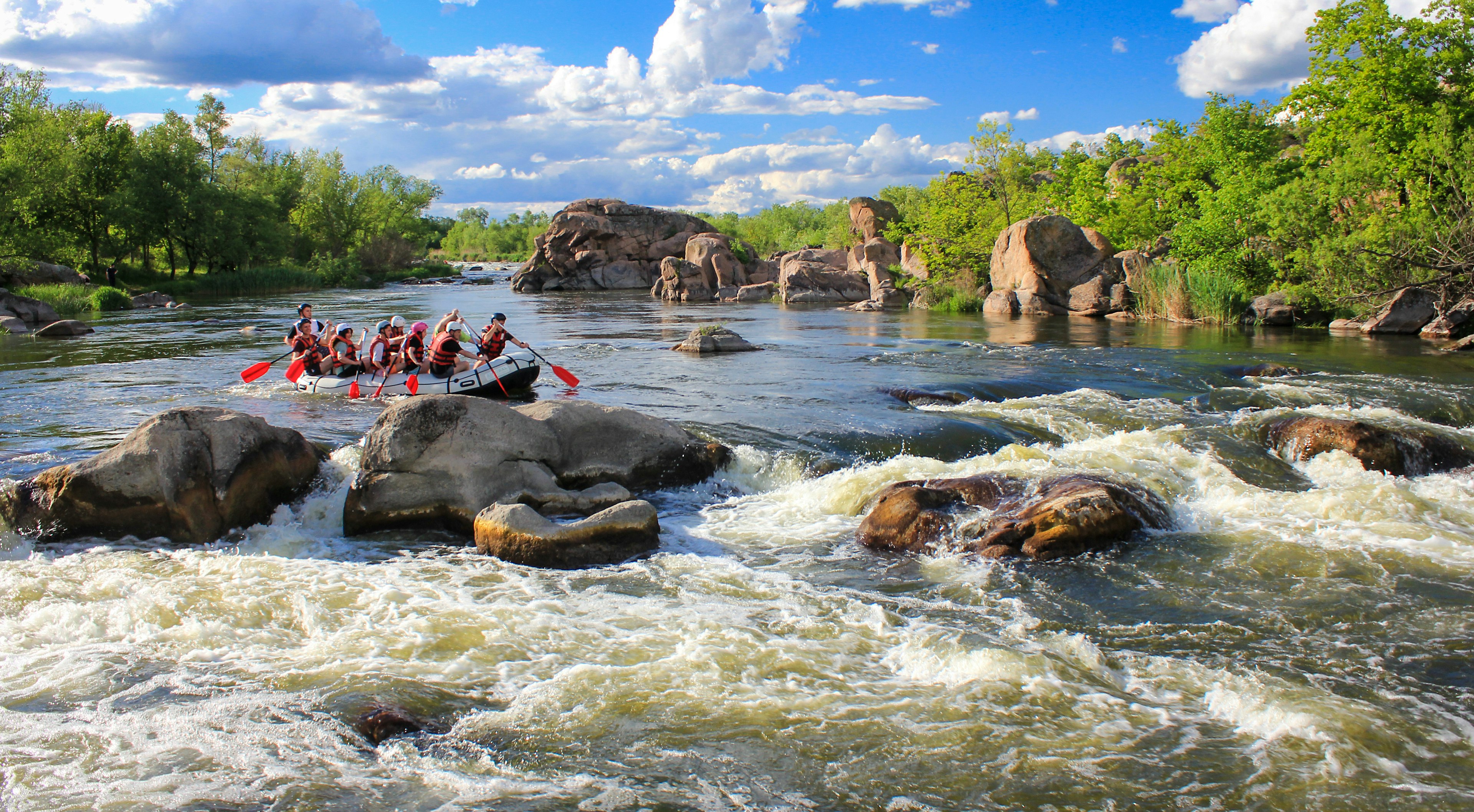 A boat full of rafters about to descend down the white water rapids of a river in Costa Rica