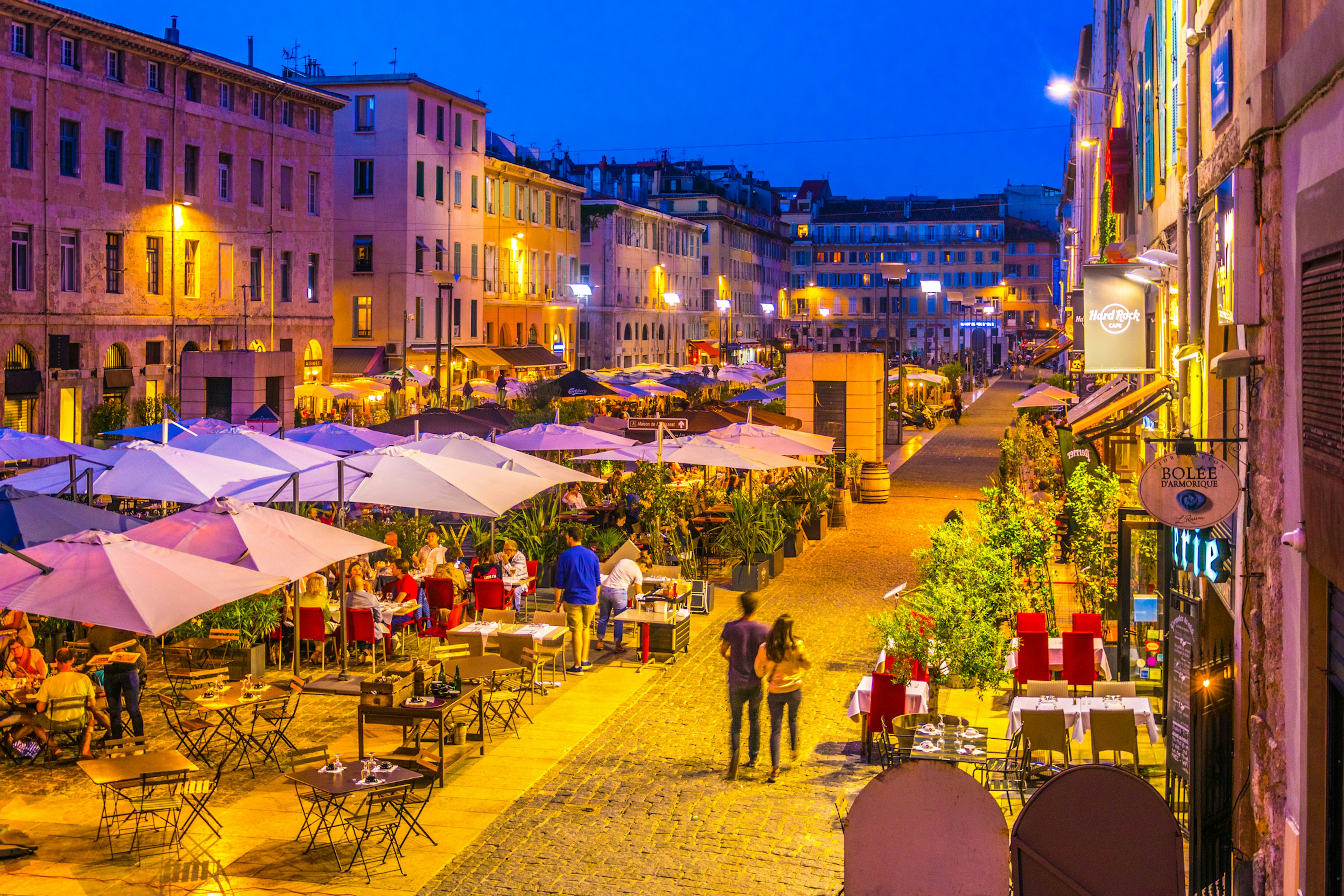 Night view of a square full of restaurants at port vieux part of Marseille, France