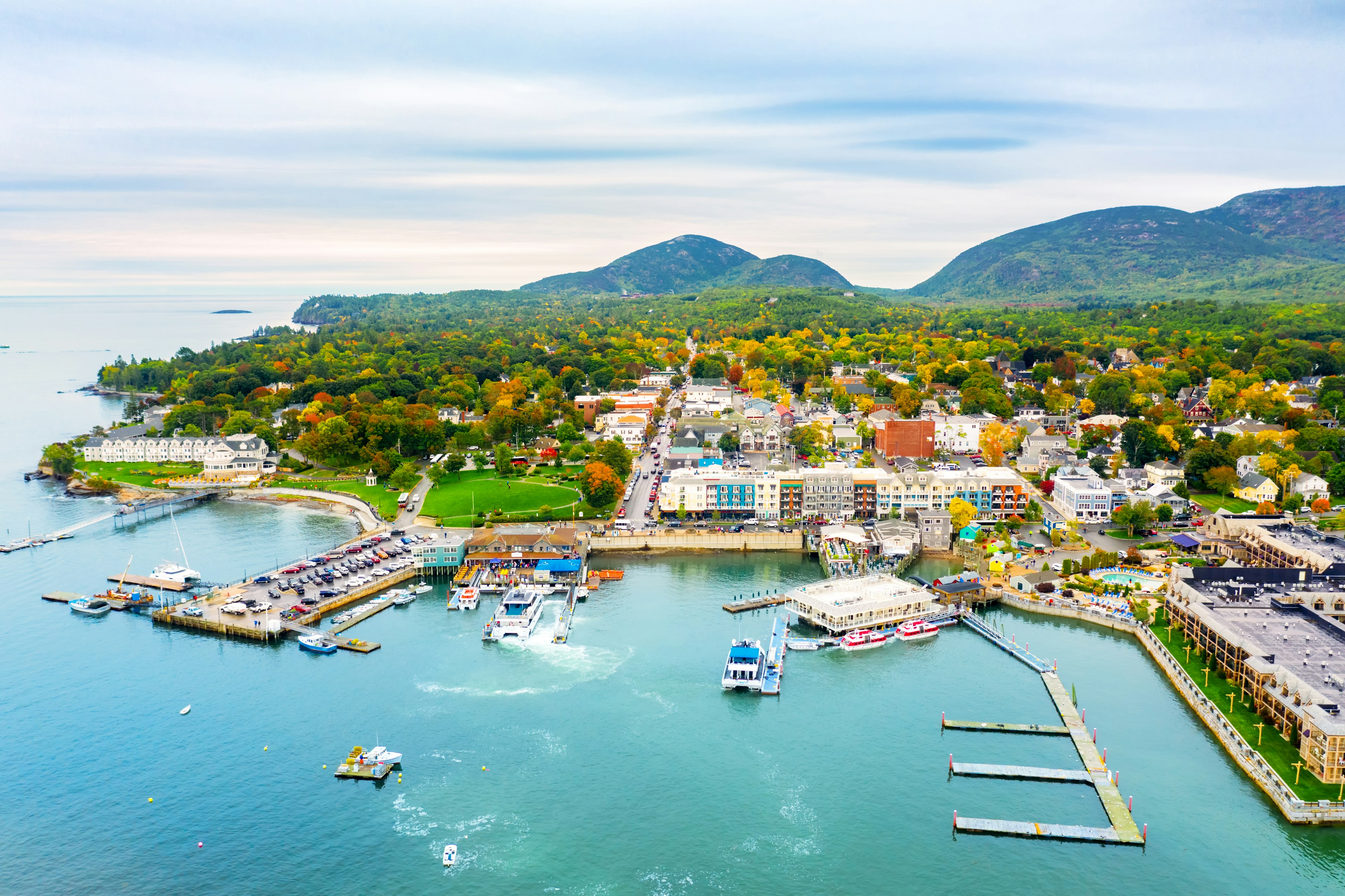 An aerial shot of a seaside town with a small harbor