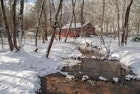 Red cabin set in the wood and sorrounded by soft white snow, some trees and a creek. Blue Ridge mountains, North of Georgia, US.
1317122122