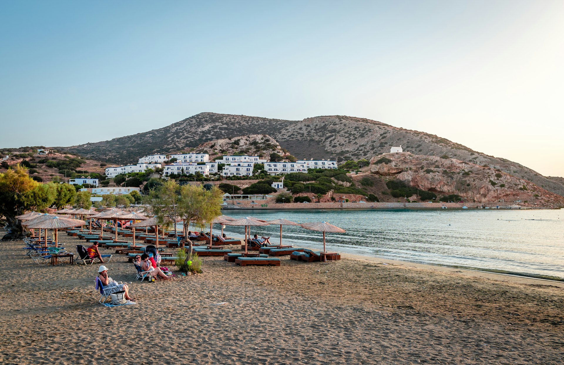 Swimmers enjoy the sunset at the beach. Galissas is a village in Syros Island