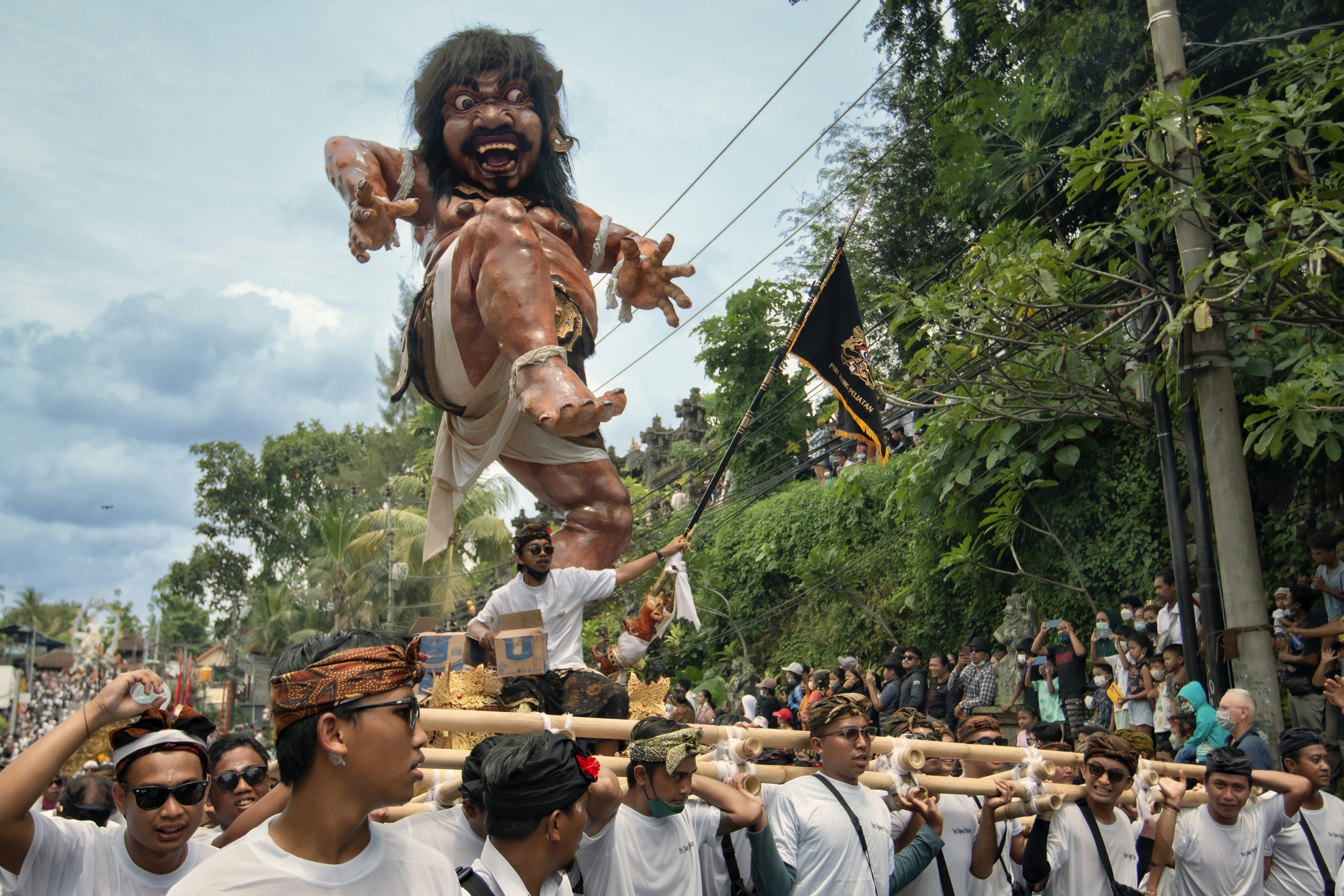 Many people are carrying an ogoh-ogoh (papier-mâché monster) in Denpasar, Bali, as part of Nyepi celebrations