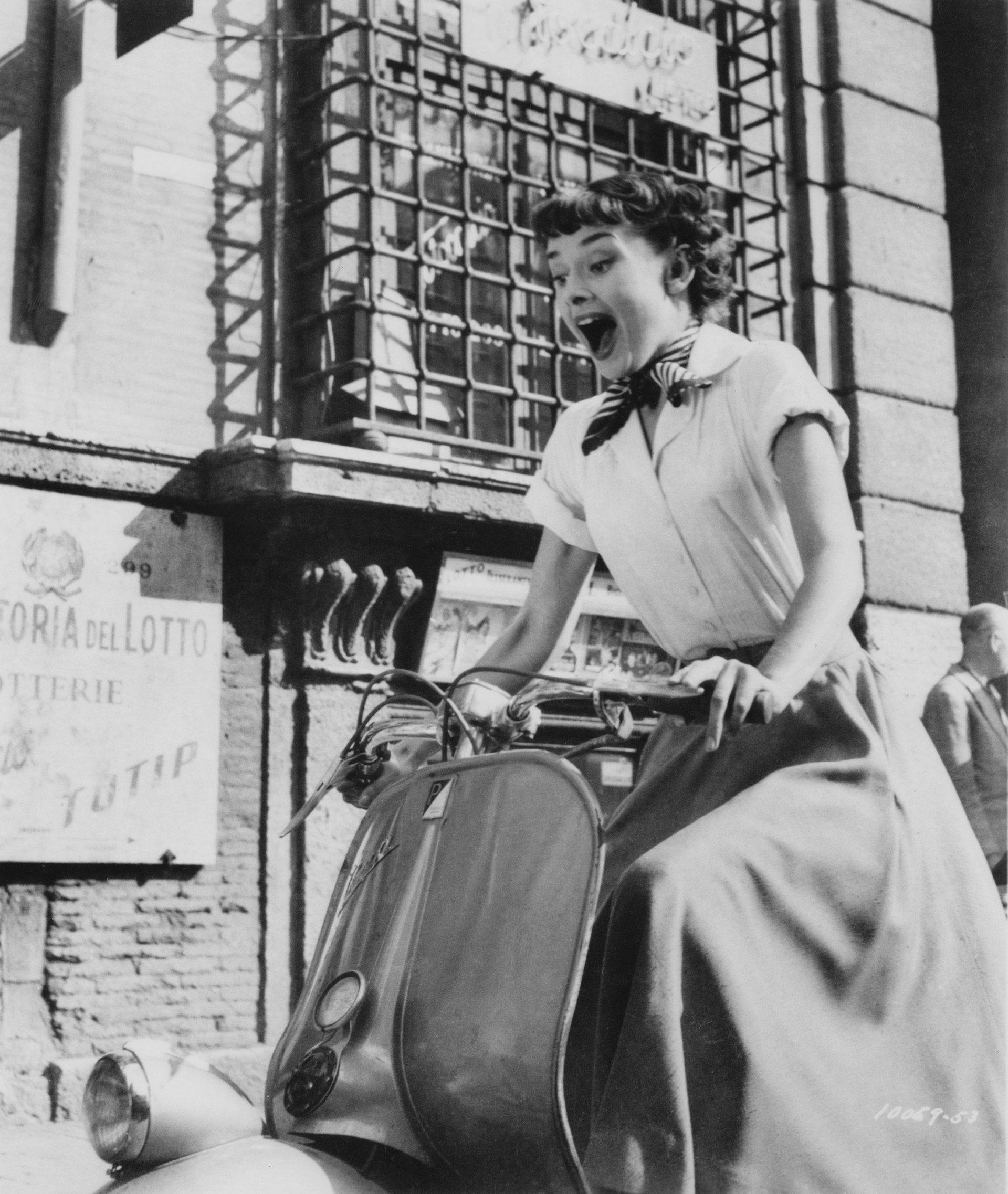 Belgian-born actress Audrey Hepburn (1929 - 1993) riding a motor scooter through Rome in a publicity still for 'Roman Holiday'