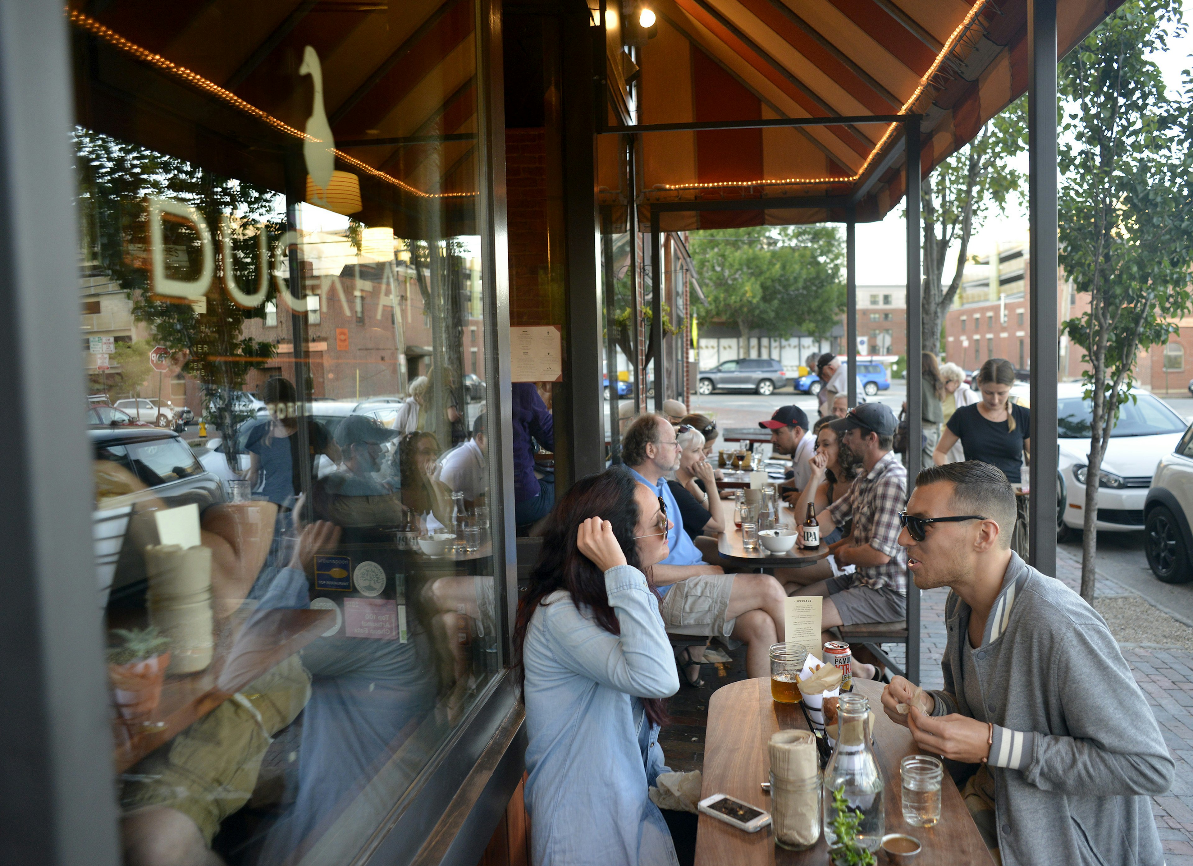 Patrons eat at outdoor tables at Duckfat restaurant, Portland, Maine, USA