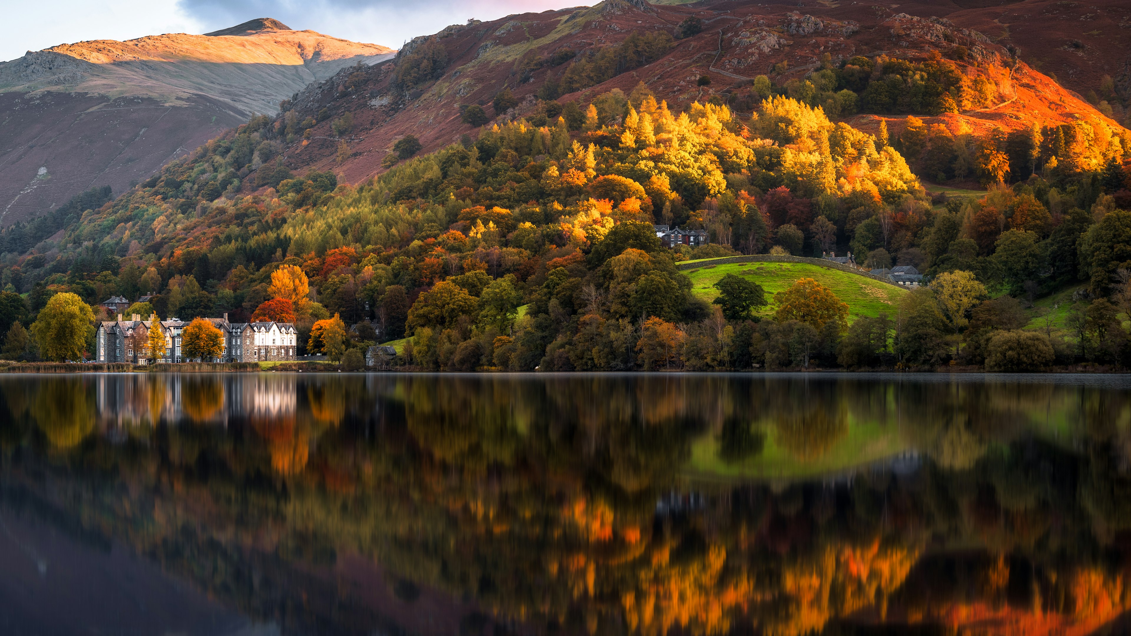 A lake reflecting the autumn colors of the surrounding woodland