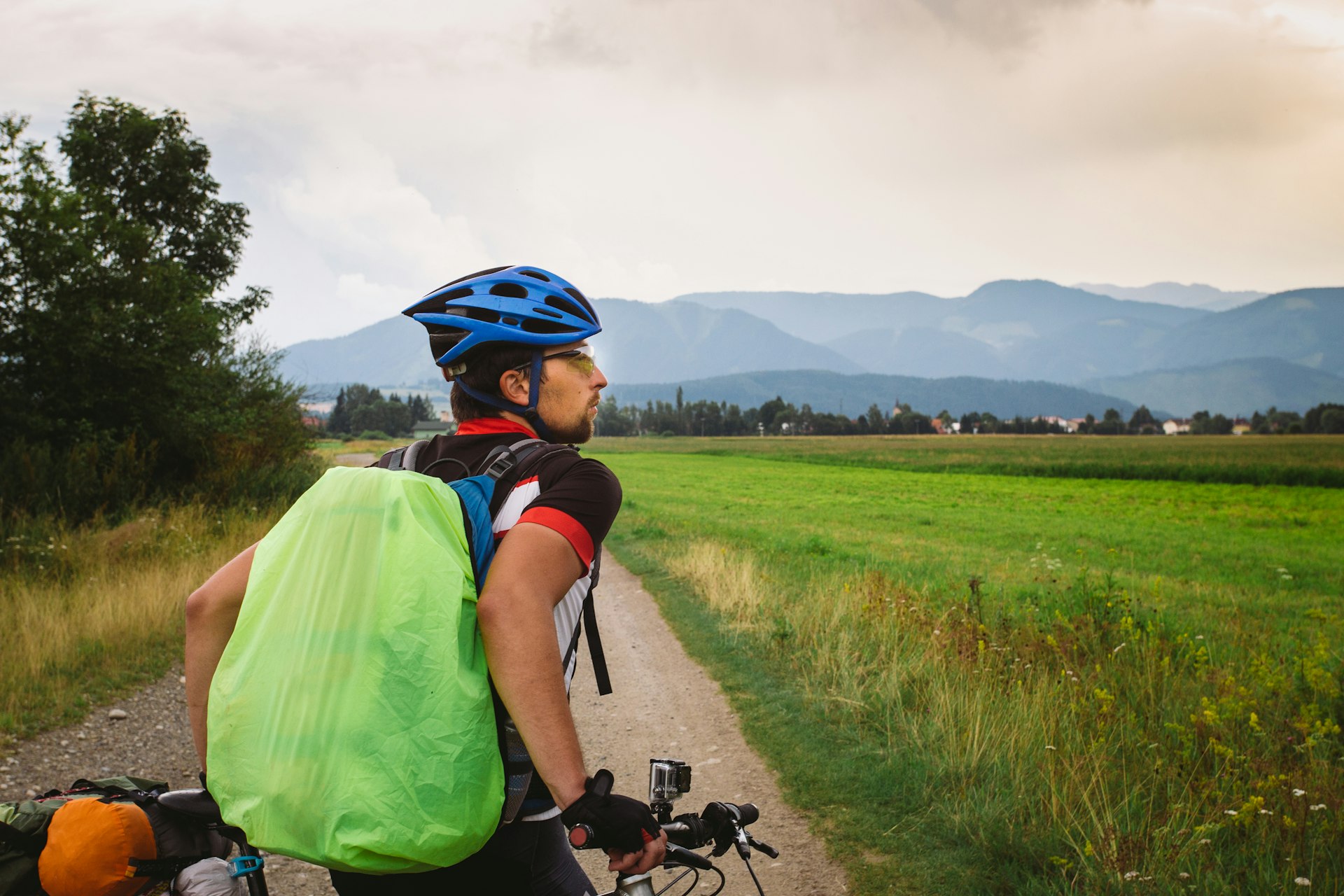 A cyclist stops to look at hills in the distance, Slovakia