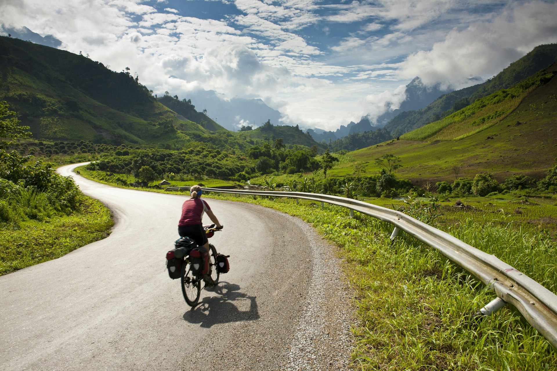 Cyclist riding on a road in Laos 