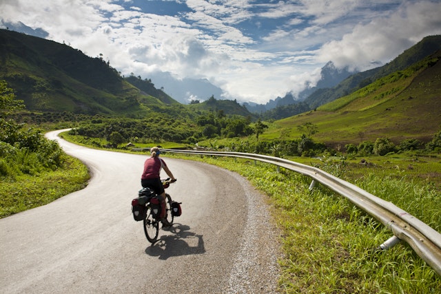 Cyclist riding on a road in Laos