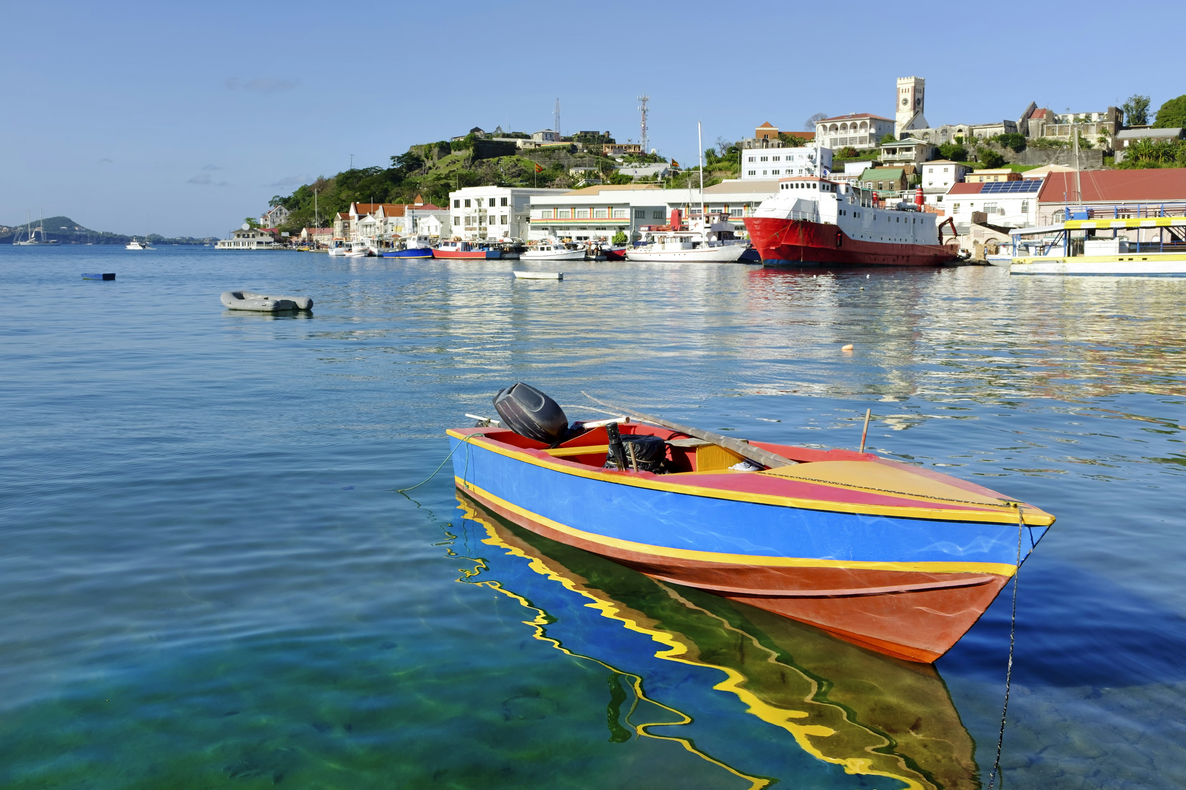 The port of St George's in Grenada with a colorful boat in the foreground