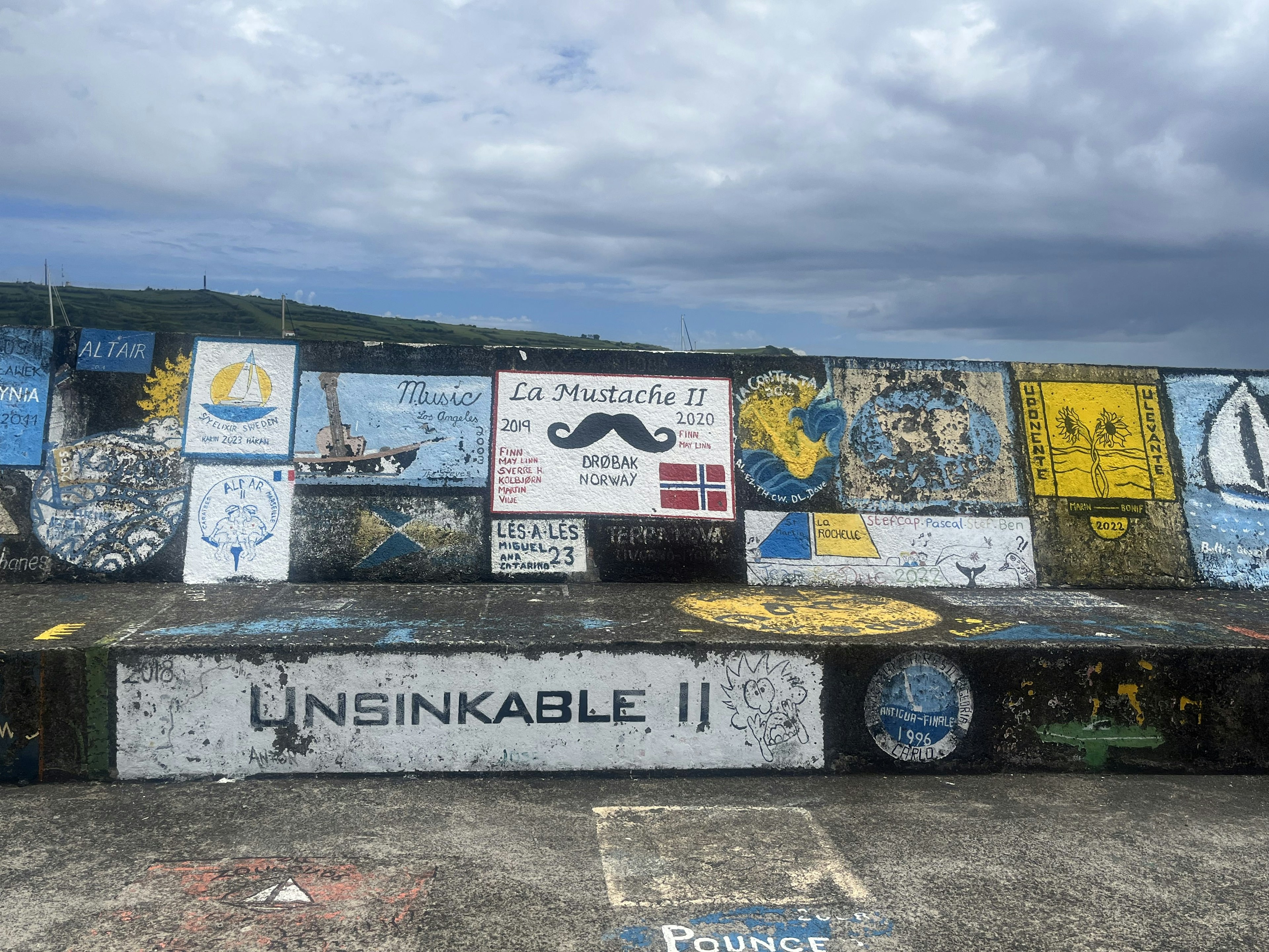 Colourful murals on Faial harbor