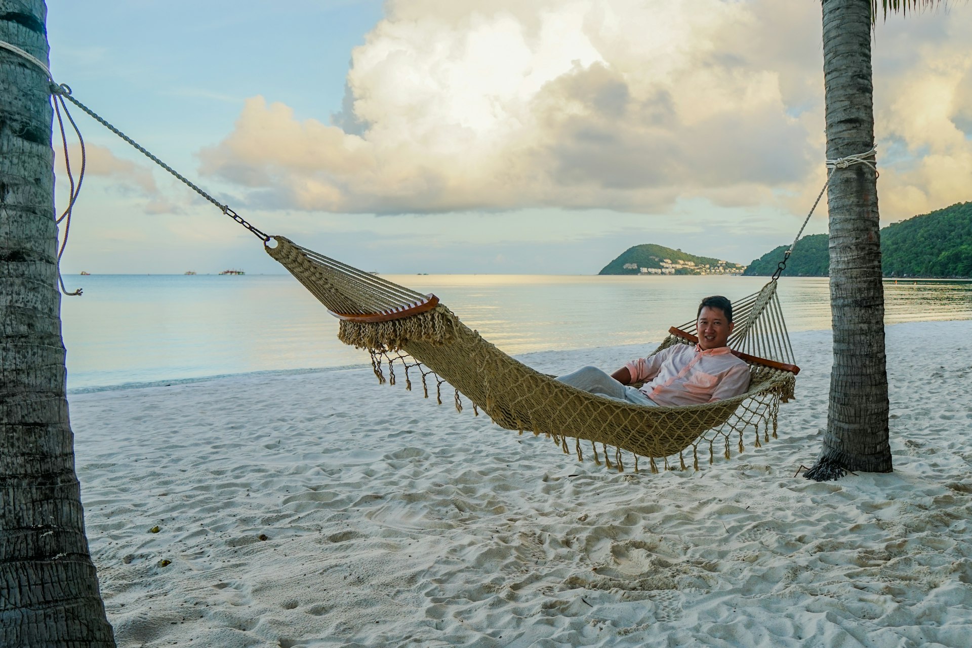 ϲʼʱ destination editor James Pham is lying on a hammock between two palm trees on Kem Beach, Phu Quoc, Vietnam