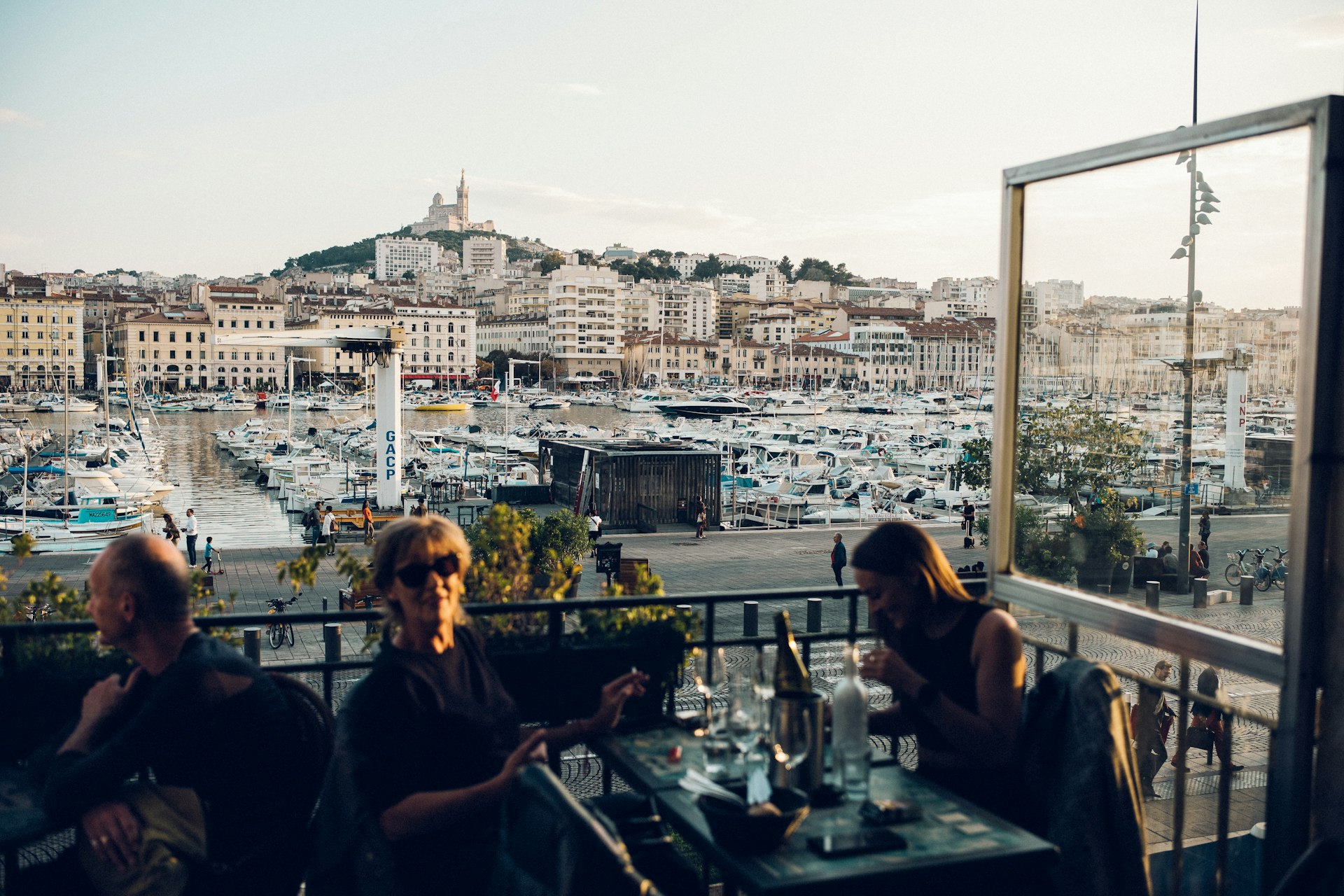 Two women overlooking the port at La Caravelle cafe in Marseille