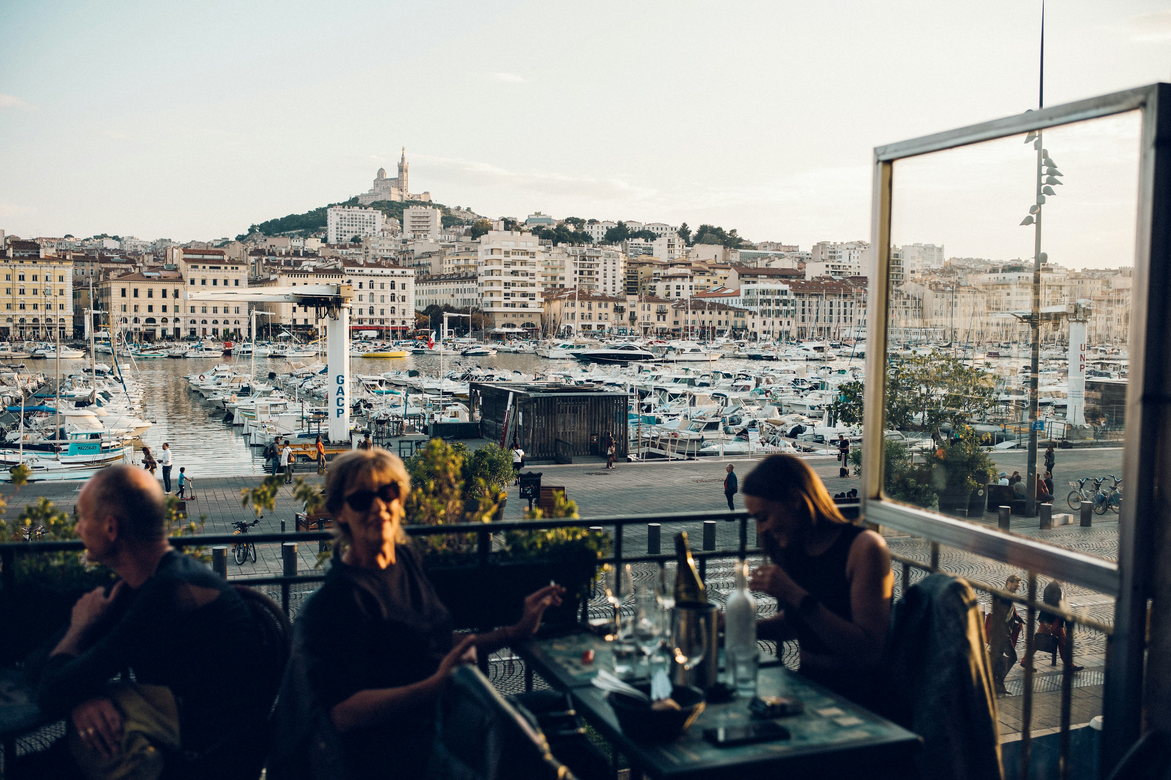 Two women overlooking the port at La Caravelle cafe in Marseille