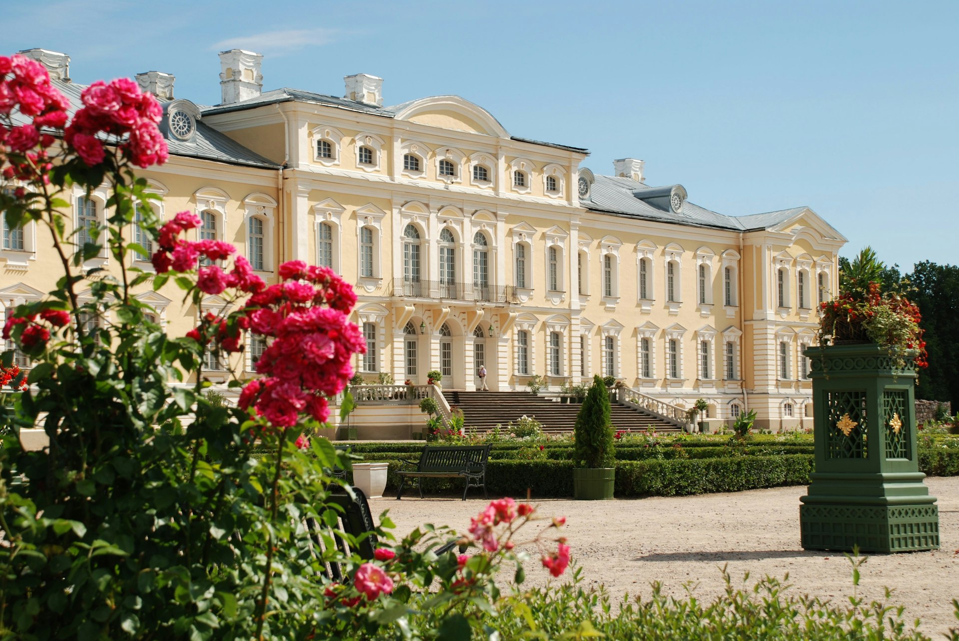 Exterior shot of an opulent palace building with grand gardens