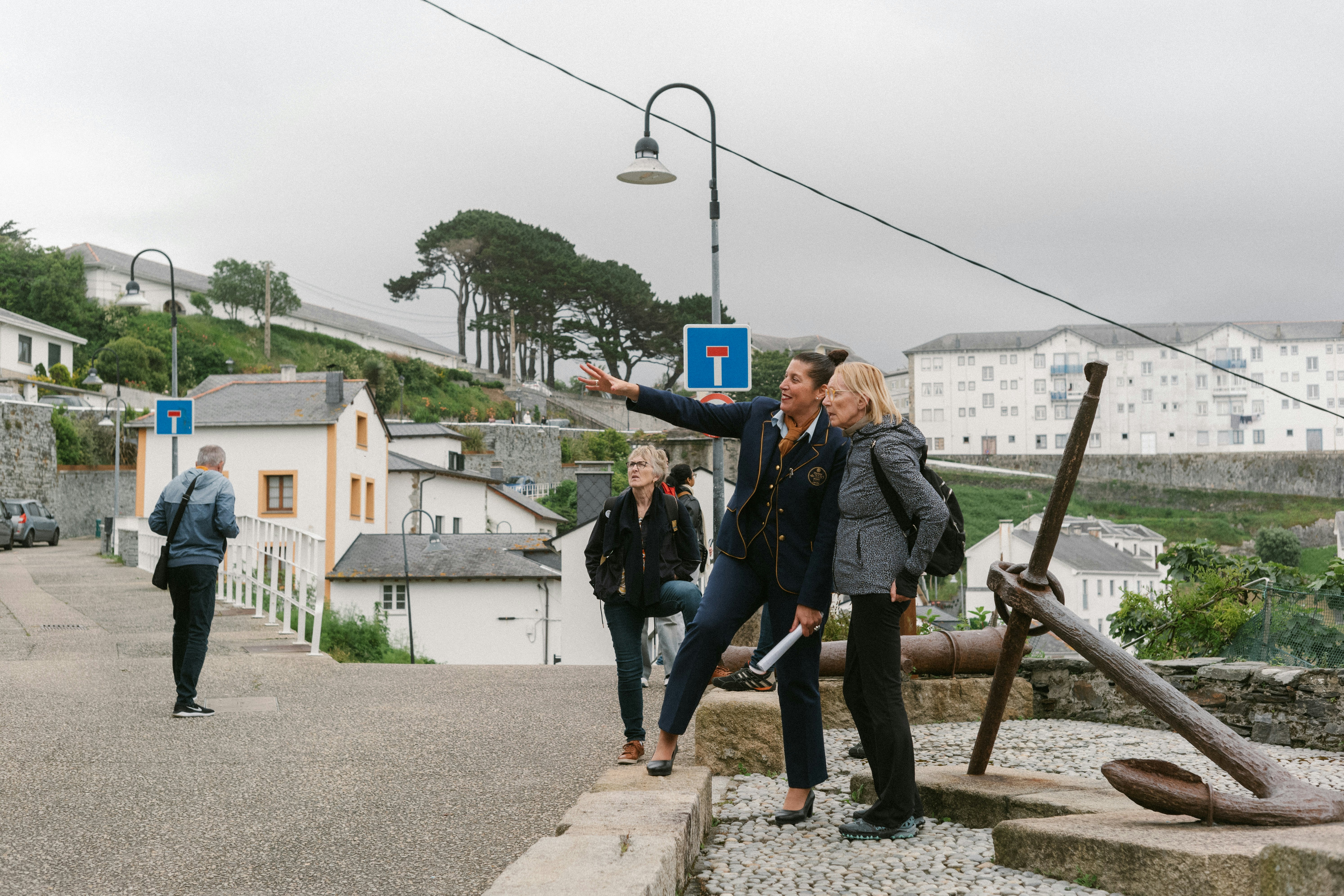 A tour guide points out something of interest to a tourist