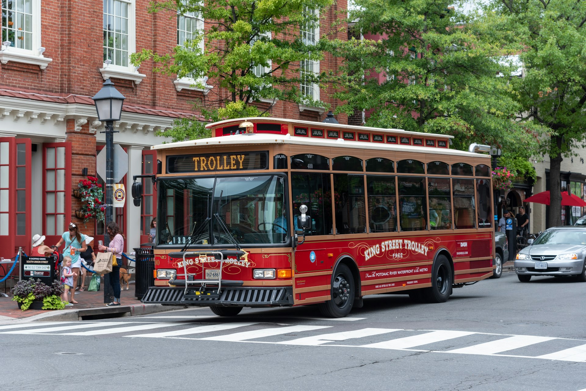  A trolley bus drives down the street in Alexandria in the summer.