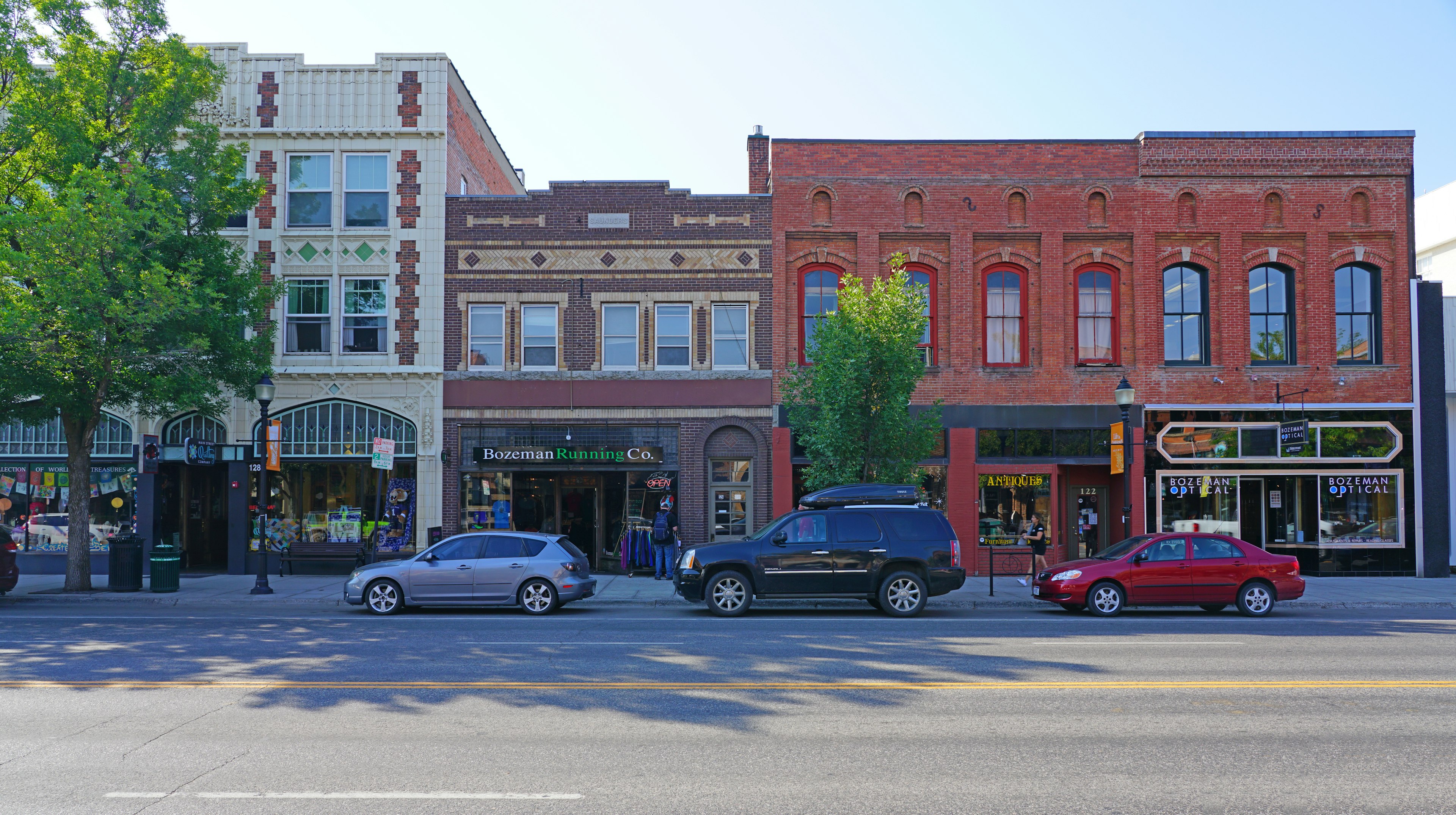 A row of shopfronts in a town on a sunny day