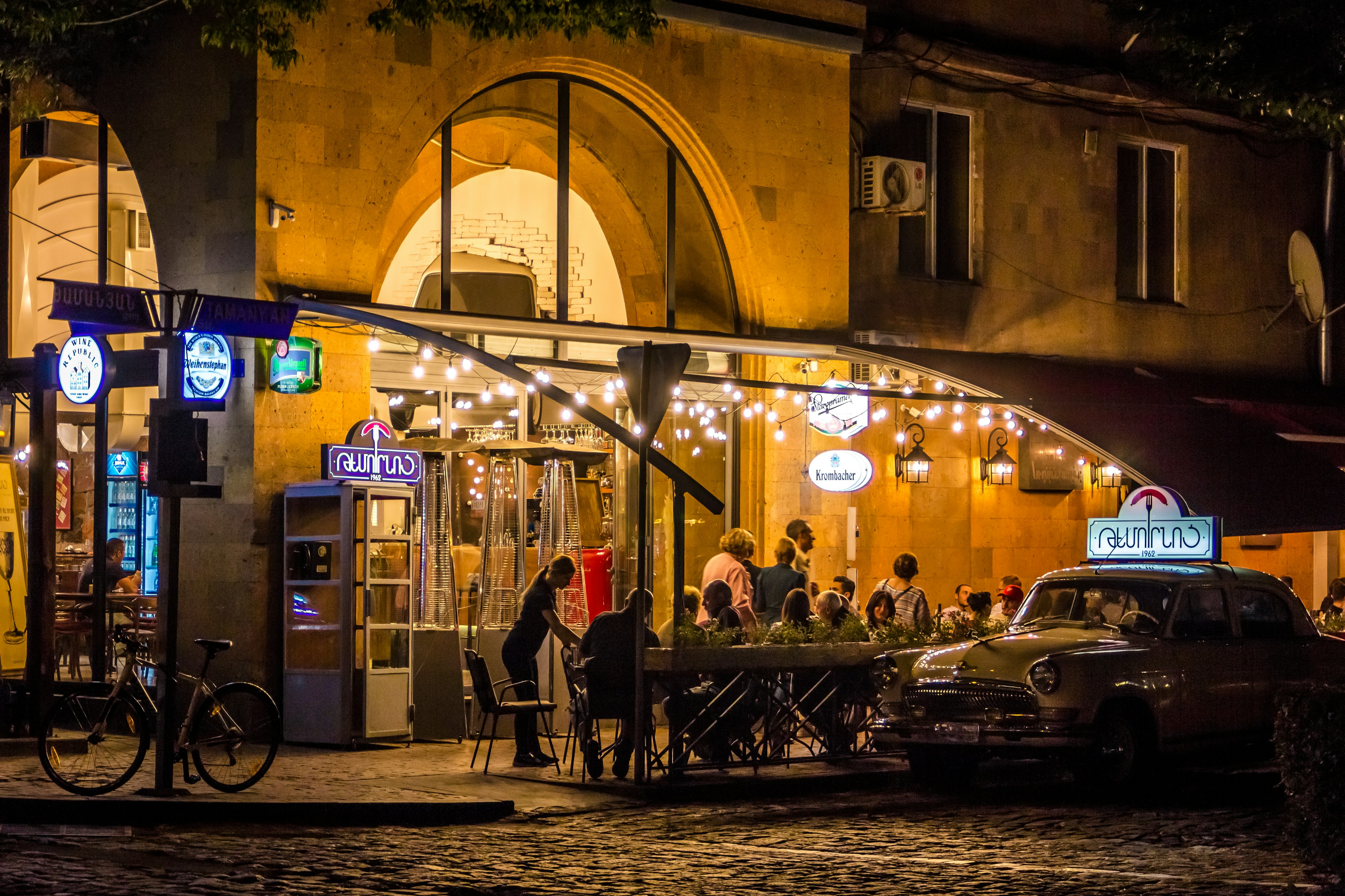 People sit at an outdoor cafe in the evening, Yerevan, Armenia