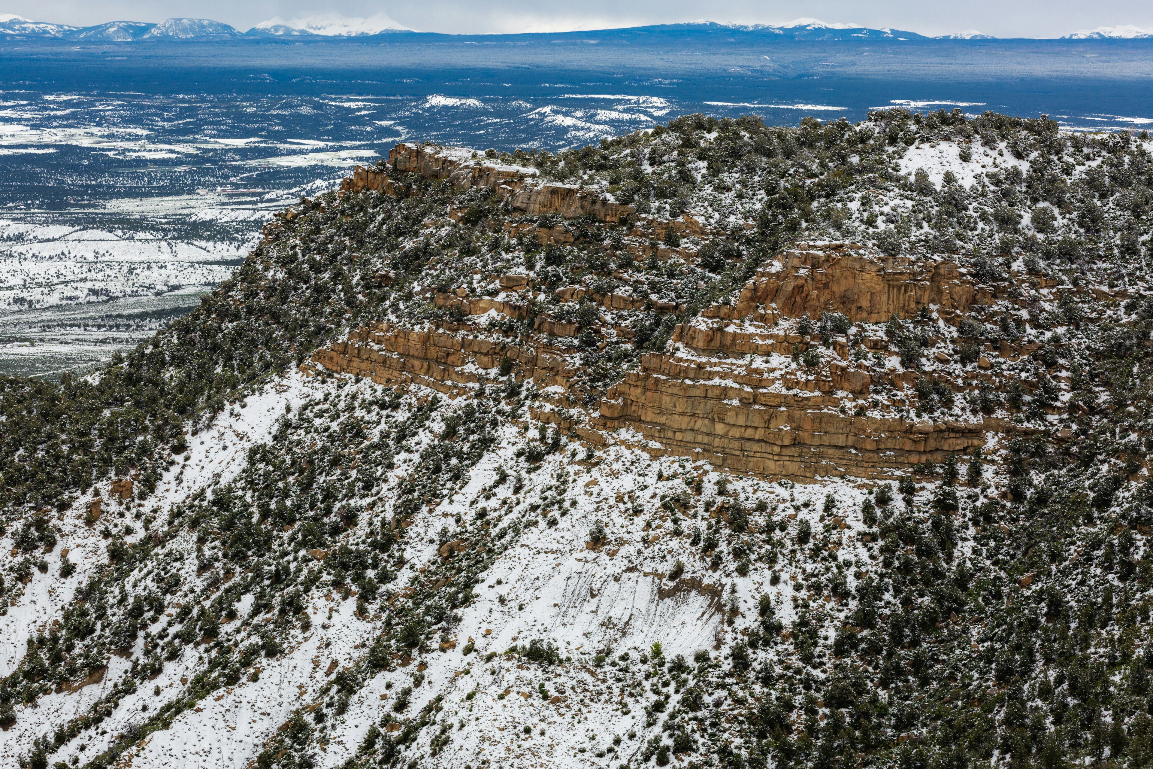 A hilly landscape with a light dusting of snow