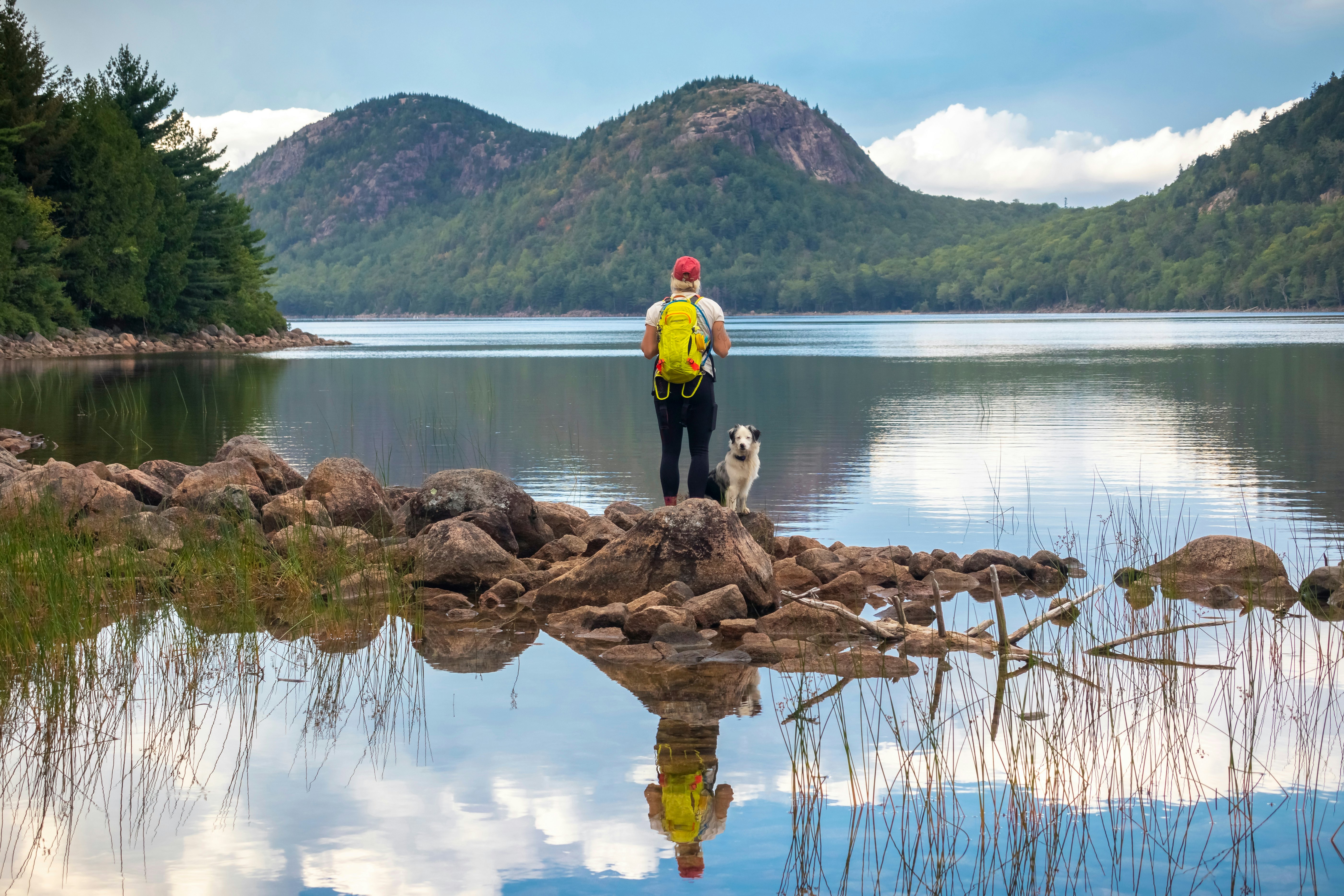 Female hiker and dog at Jordan Pond and The Bubbles, Acadia National Park, Maine