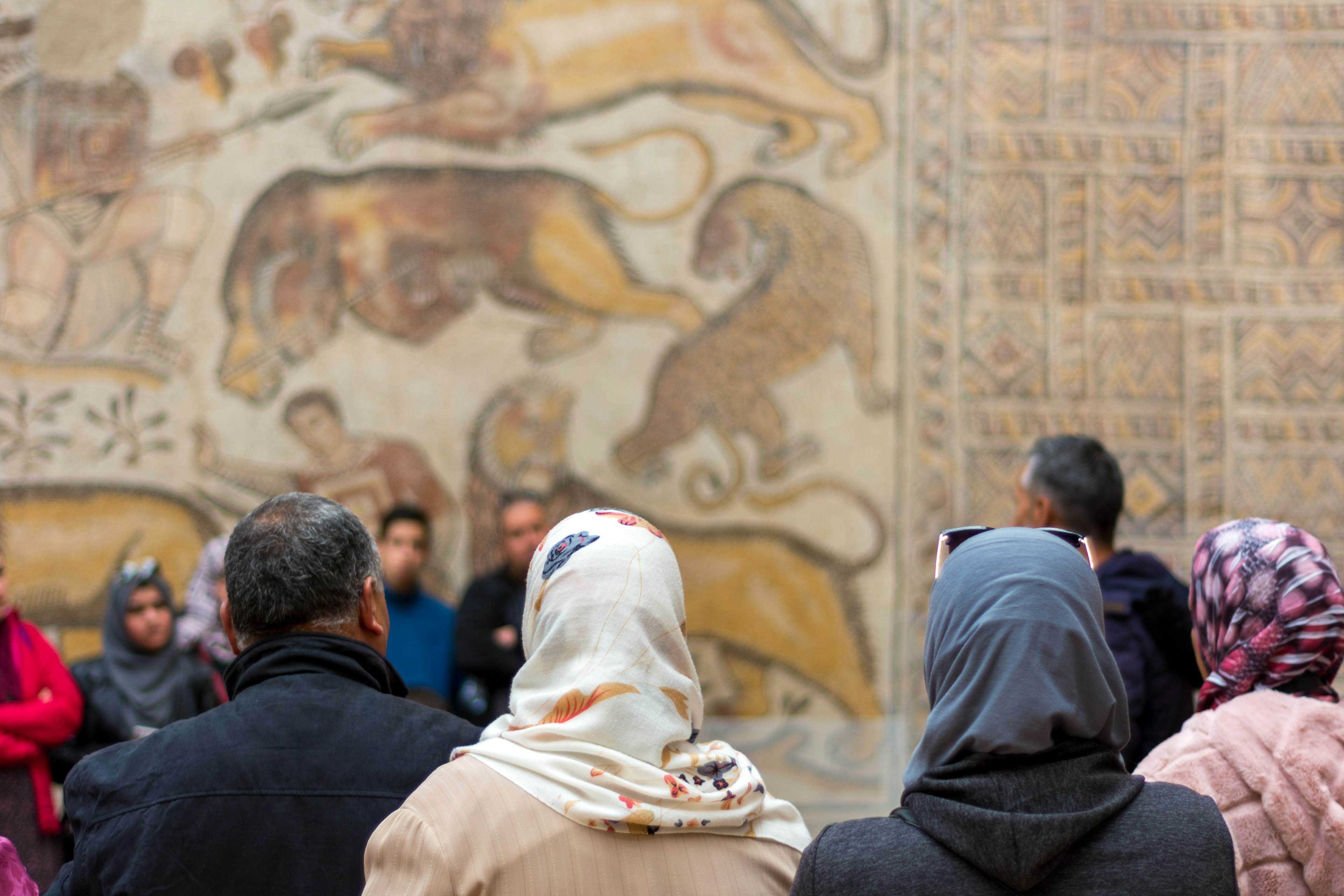 A view of tourists admiring the ancient mosaics at Djemila, Algeria