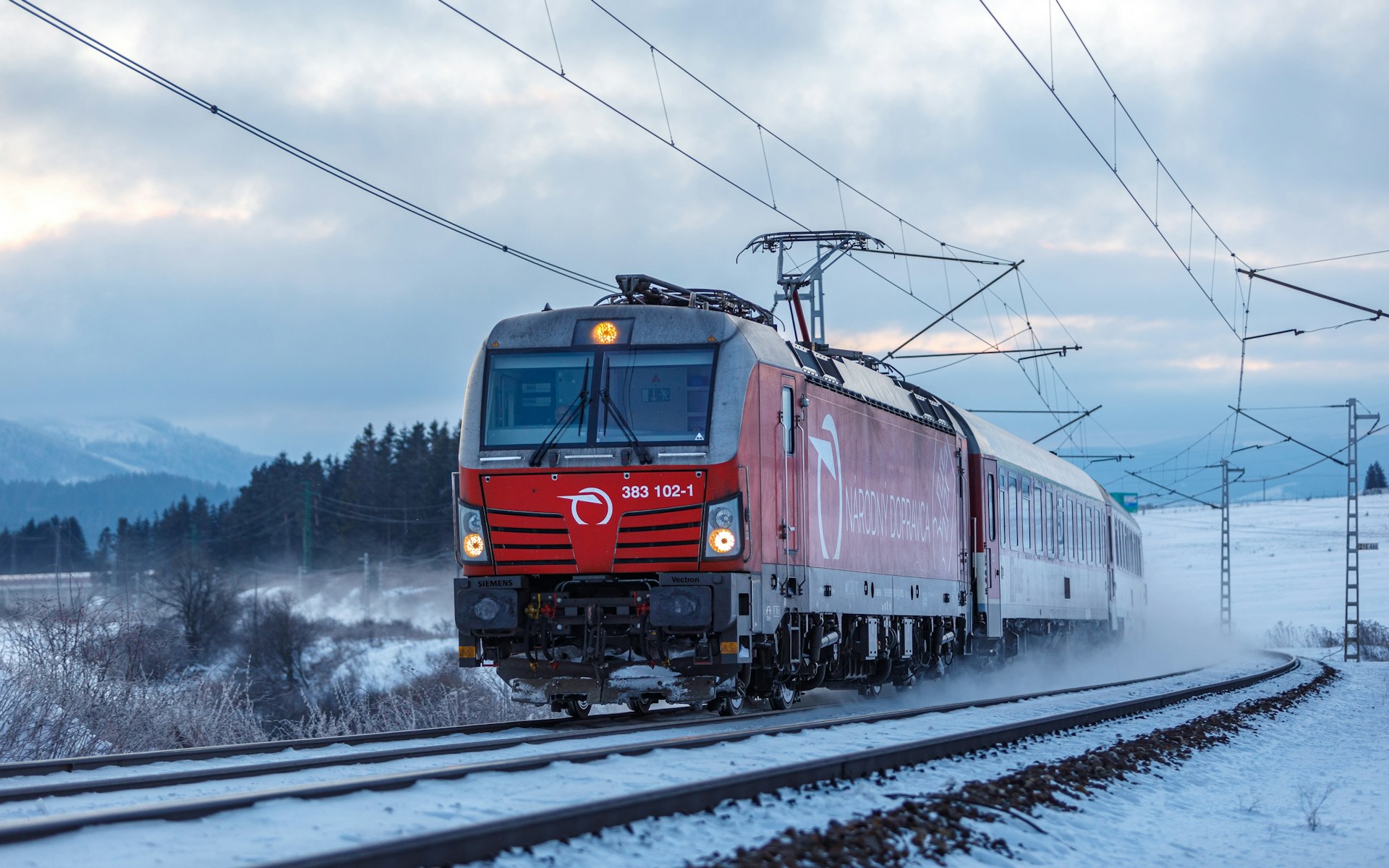 Passenger express train from Bratislava to Košice along a snowy track, Štrba, Slovakia