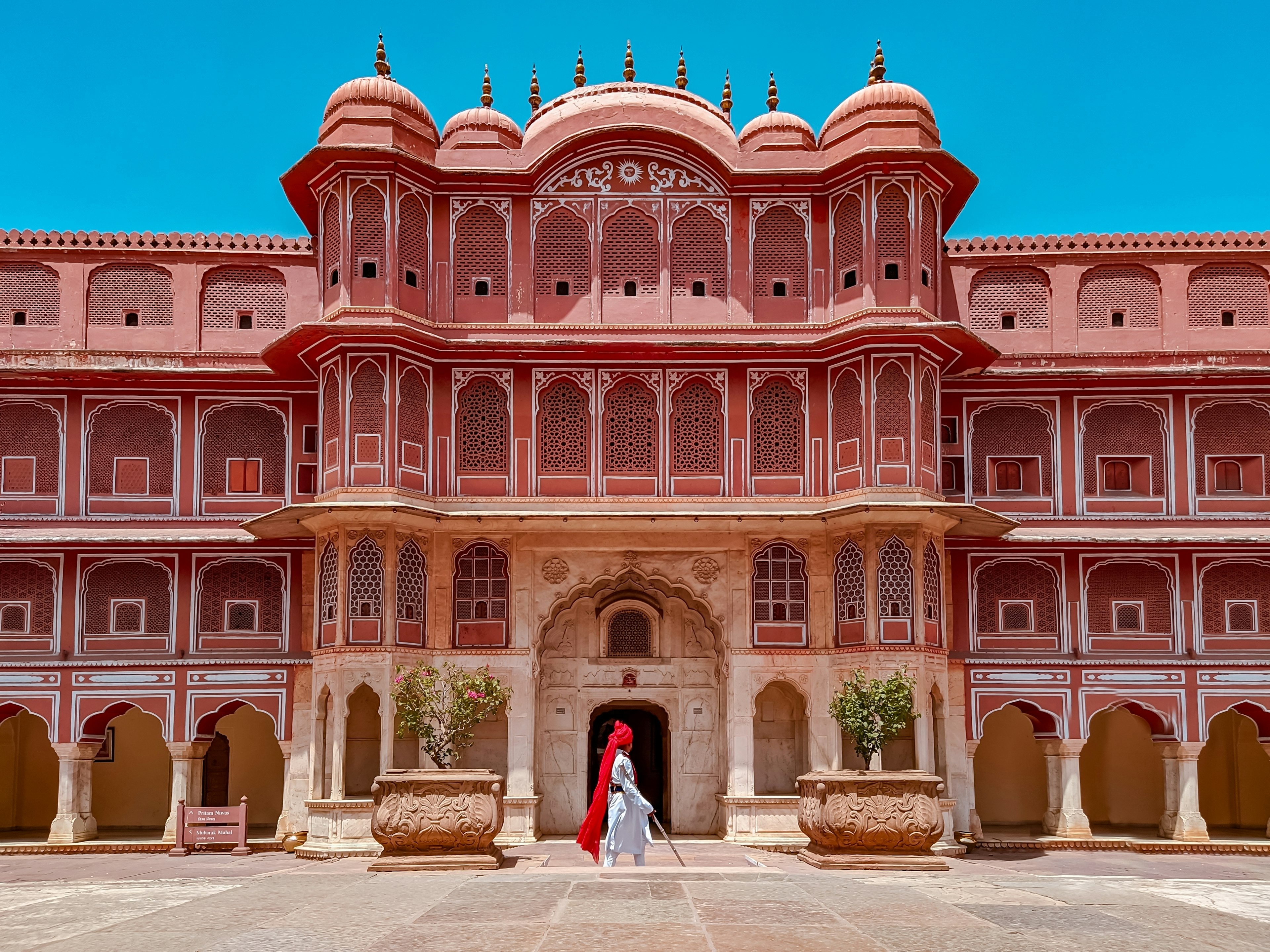 A vast palace building painted red with white detail around its ornate windows