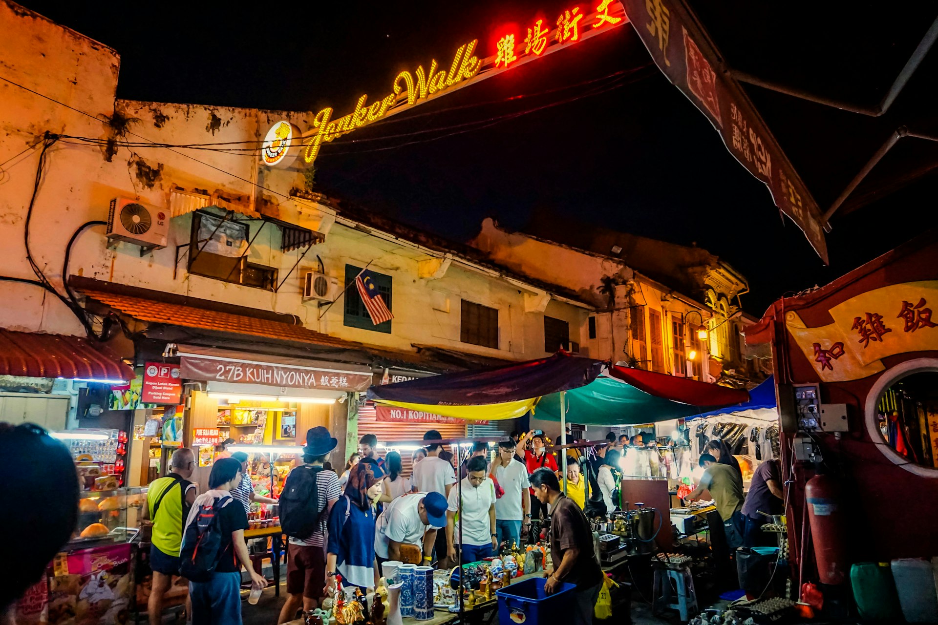 People browse market stalls at night on Jonker Walk in China town.