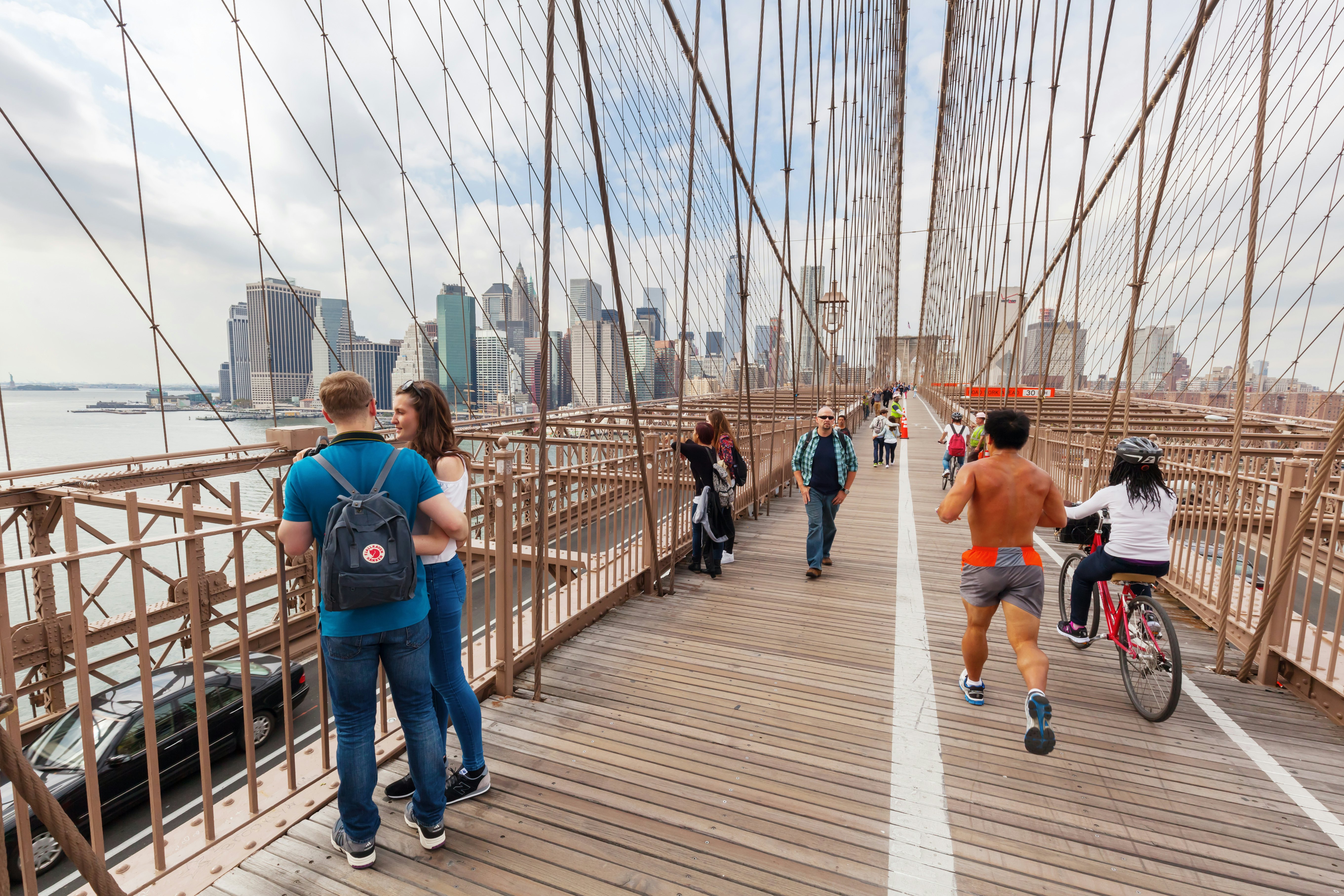 Pedestrians and cyclists on Brooklyn Bridge.