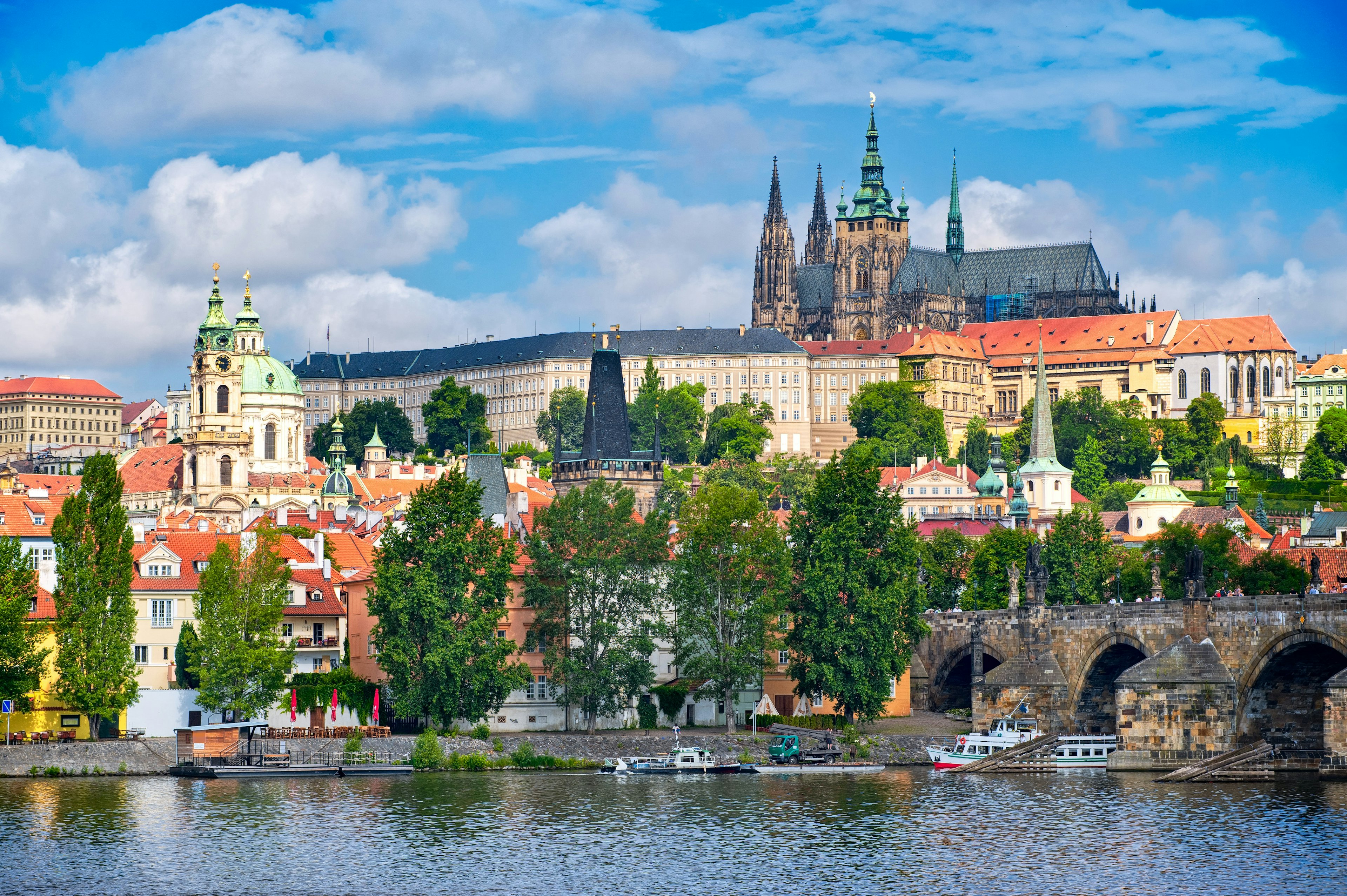 A castle and cathedral sits on a hill above a river